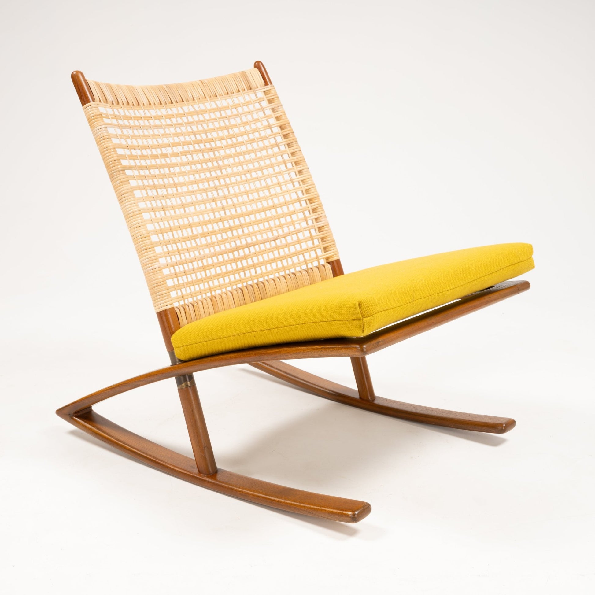 Side view of Fredrik Kayser Model 599 rocking chair with woven backrest, teak frame, and mustard yellow wool cushion