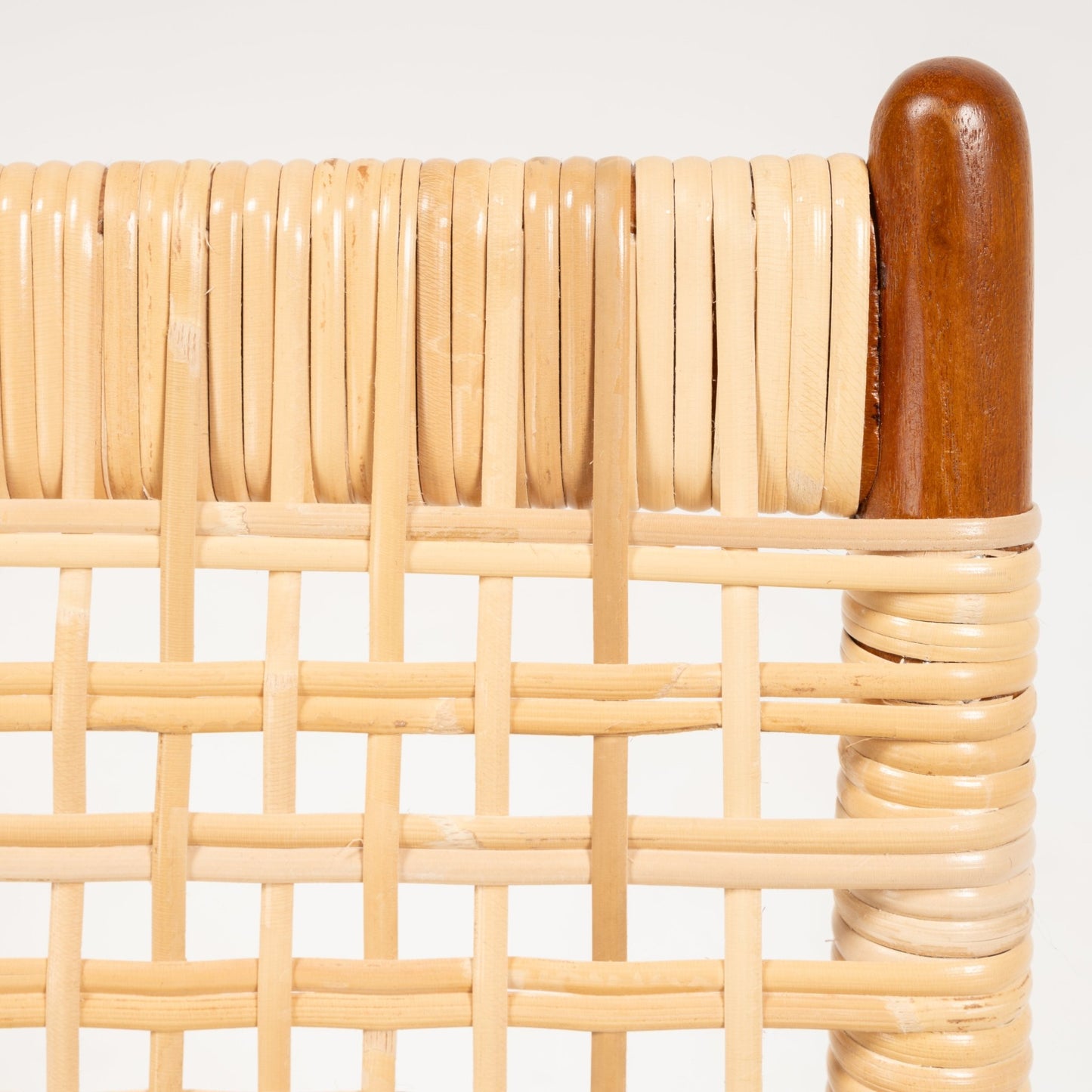 Close-up of woven cane seat detail with smooth teak frame corner of Fredrik Kayser Model 599 rocking chair