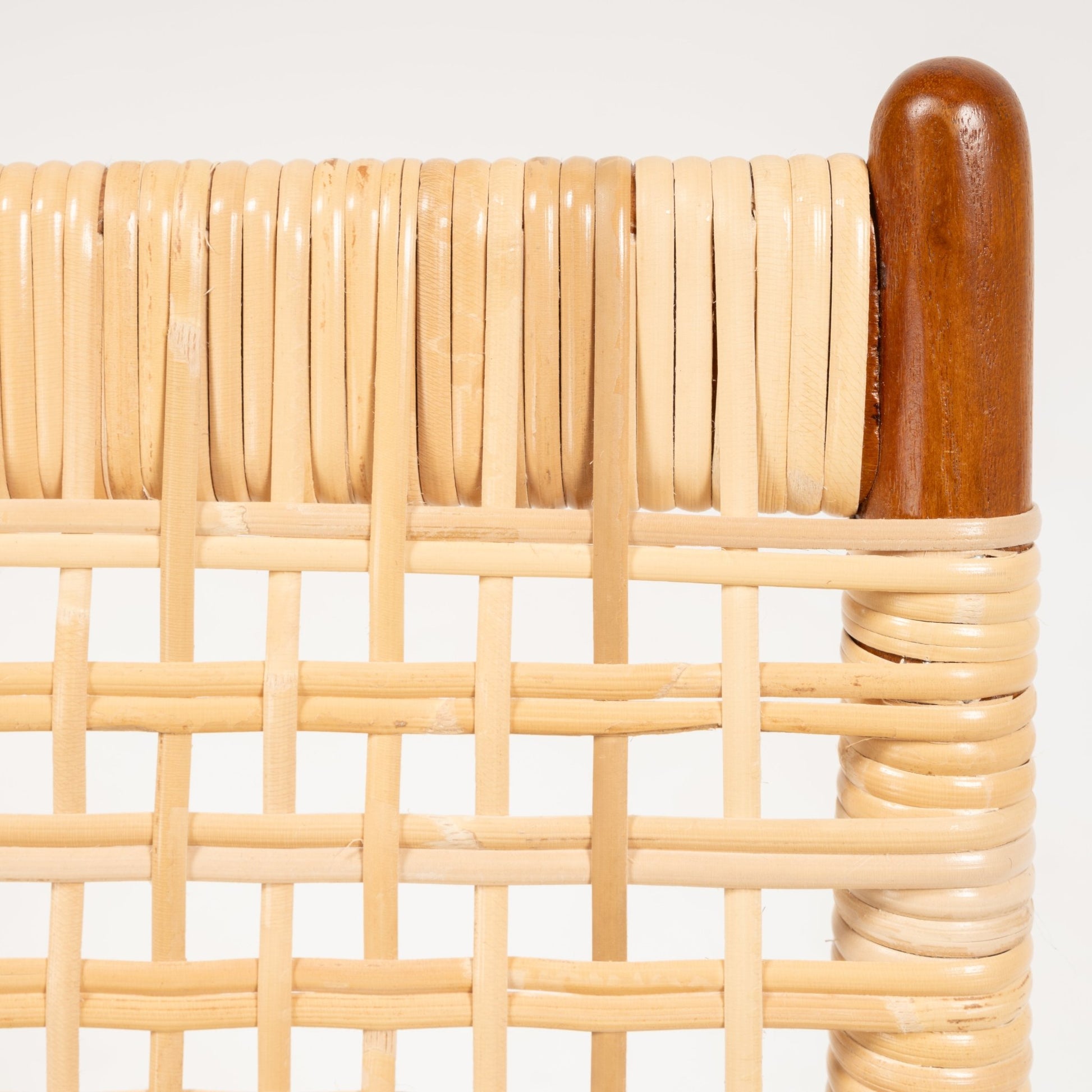 Close-up of woven cane seat detail with smooth teak frame corner of Fredrik Kayser Model 599 rocking chair