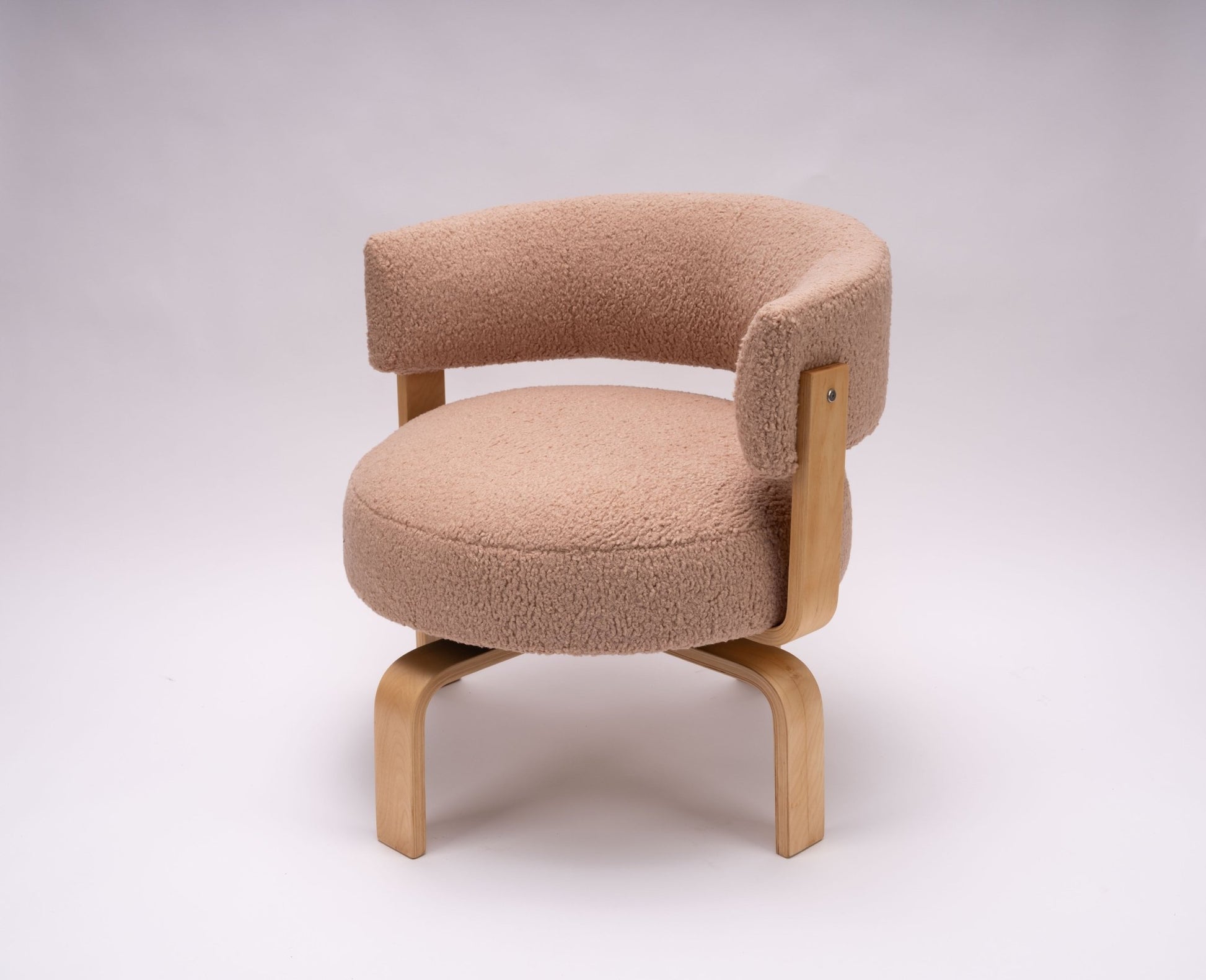 Swedish 2000s Fridene swivel chair with curved faux sheepskin seat and beechwood frame on white background.