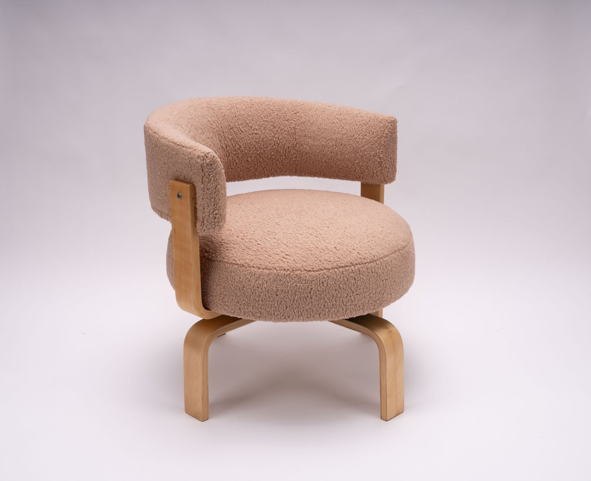 Mid-century modern Fridene swivel armchair with maharam faux sheepskin upholstery and curved beechwood frame.