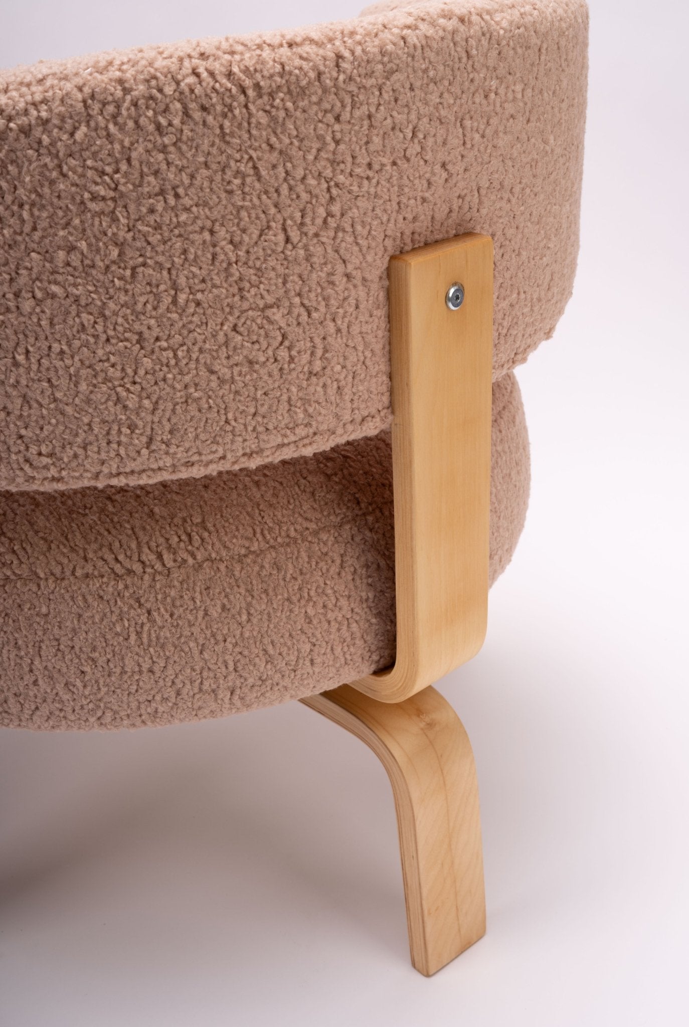 Close-up of Fridene swivel chair leg and backrest in light beechwood and textured beige faux sheepskin upholstery