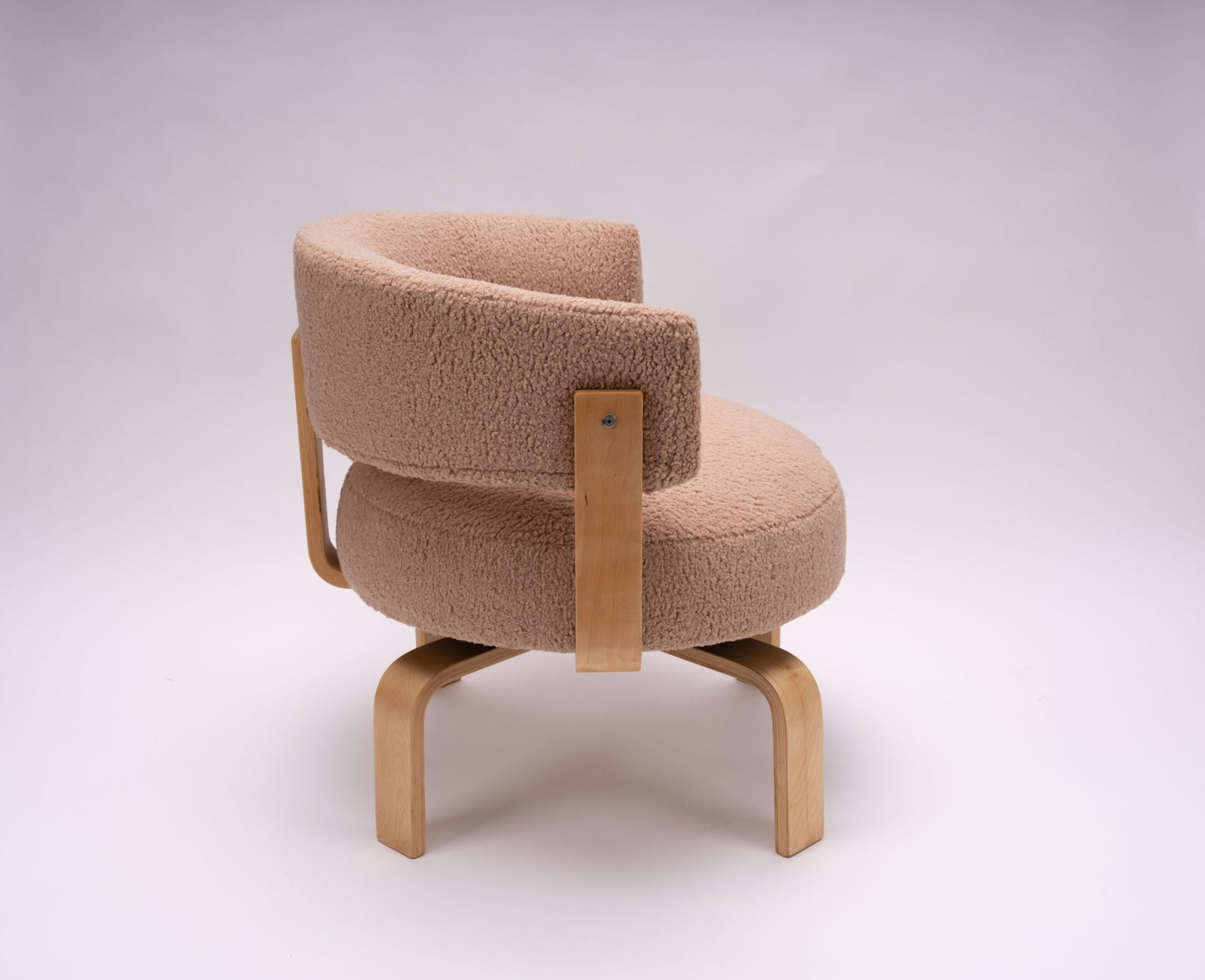 Mid-century modern swivel armchair with beechwood frame and plush faux sheepskin upholstery in soft beige tone.