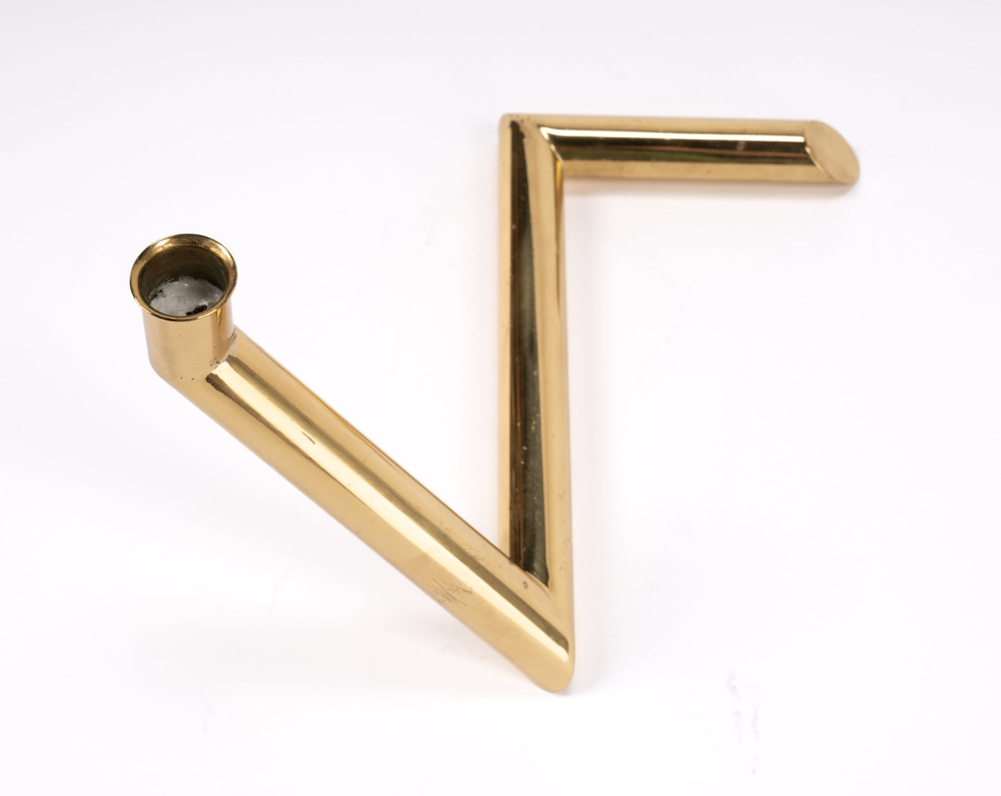 1970s Danish Go Products brass candle holder with polished finish and angular zigzag tubular design on white background