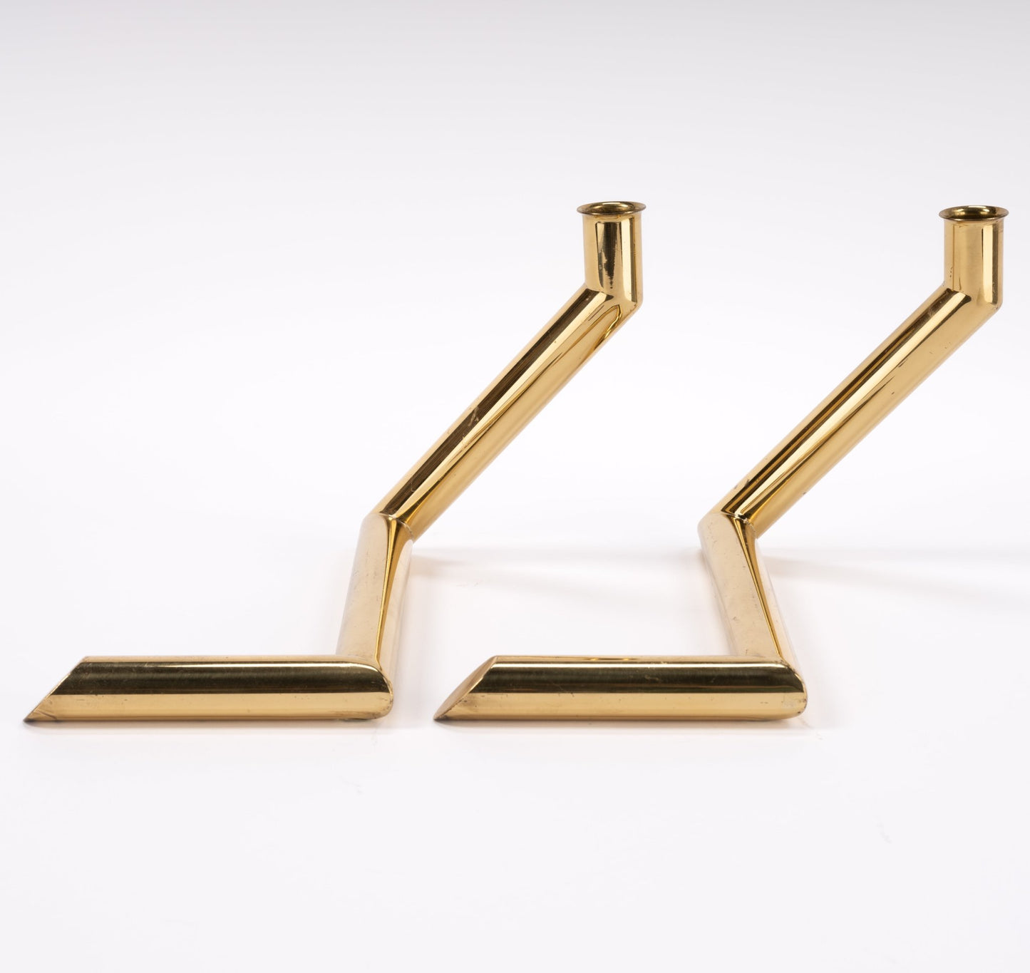 Pair of 1970s Danish Go Products brass candle holders with polished zigzag tubular design on white background