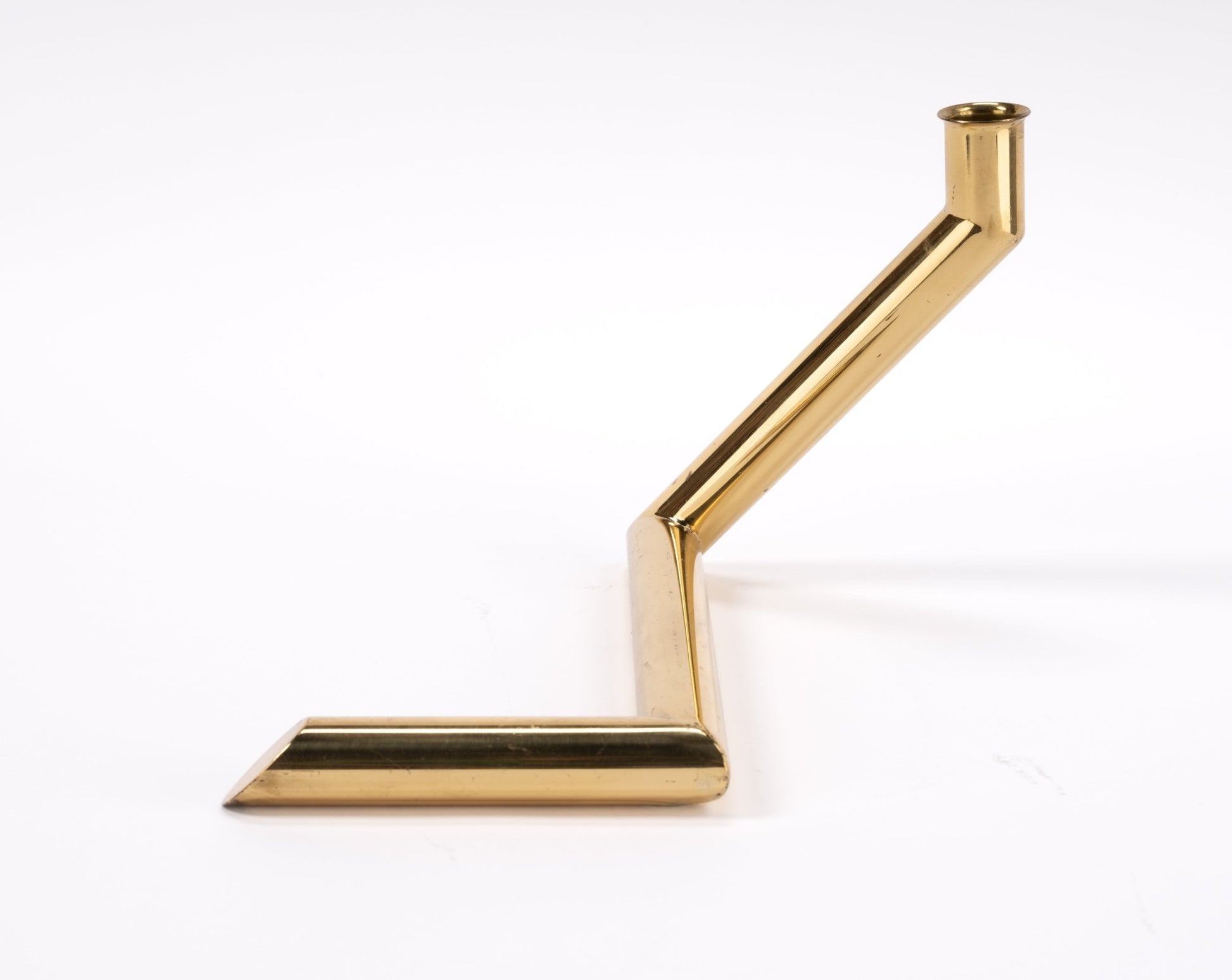 1970s Danish Go Products polished brass candle holder with angular zigzag tubular design on white background