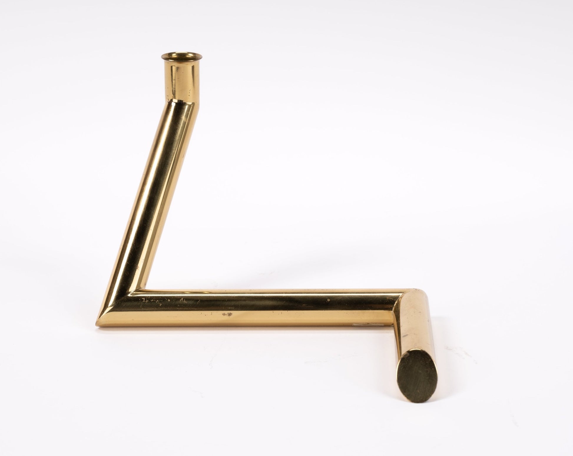 1970s Danish Go Products brass candle holder with minimalist angular tubular form and polished finish on white background