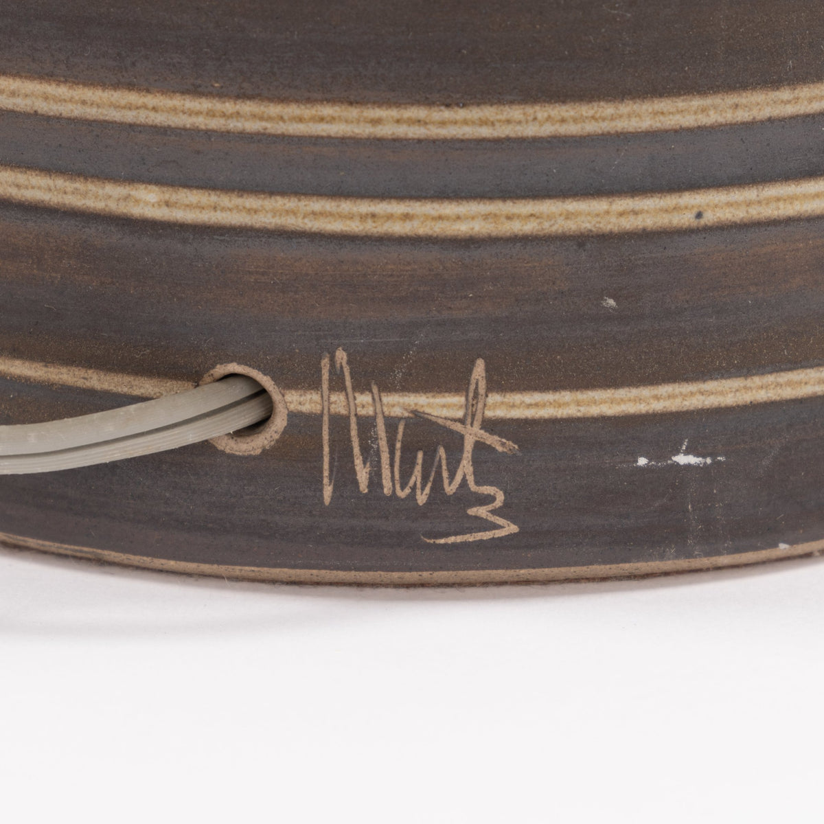 Gordon & Jane Martz Table Lamp close-up showing a dark striped ceramic base, cord opening, and hand-signed detail in mid century modern lighting style