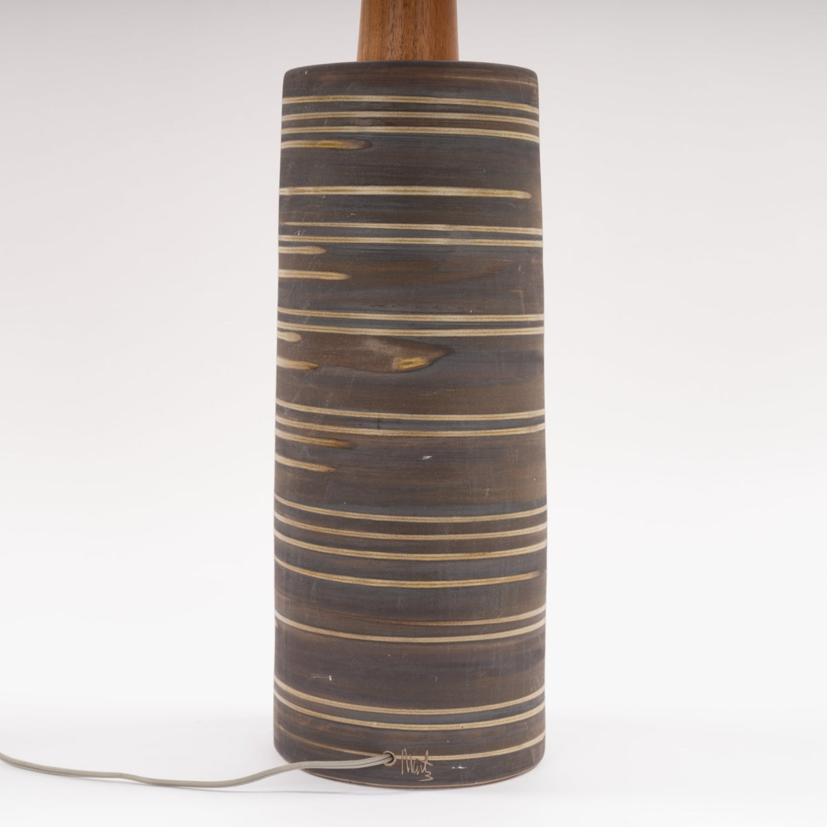 Gordon & Jane Martz Table Lamp with a dark striped ceramic cylinder base wooden neck and exposed cord in mid century modern lighting style