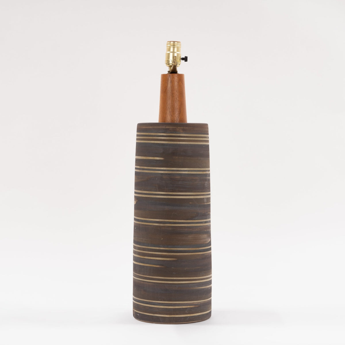 Gordon & Jane Martz Table Lamp with a dark striped ceramic base warm wood neck and exposed brass socket in mid century modern furniture style