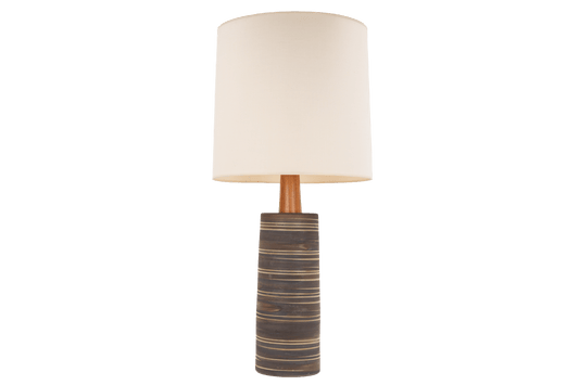 Gordon & Jane Martz Table Lamp with a striped ceramic base wooden stem and cream drum shade displayed against a black background in mid century modern lighting style