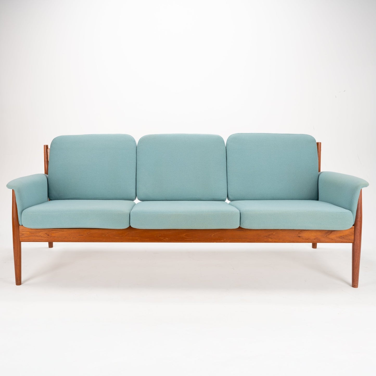 Grete Jalk Model 118 Teak Sofa showcasing a streamlined teak frame with gently tapered legs and armrests, featuring soft blue upholstered cushions for classic mid century modern seating.