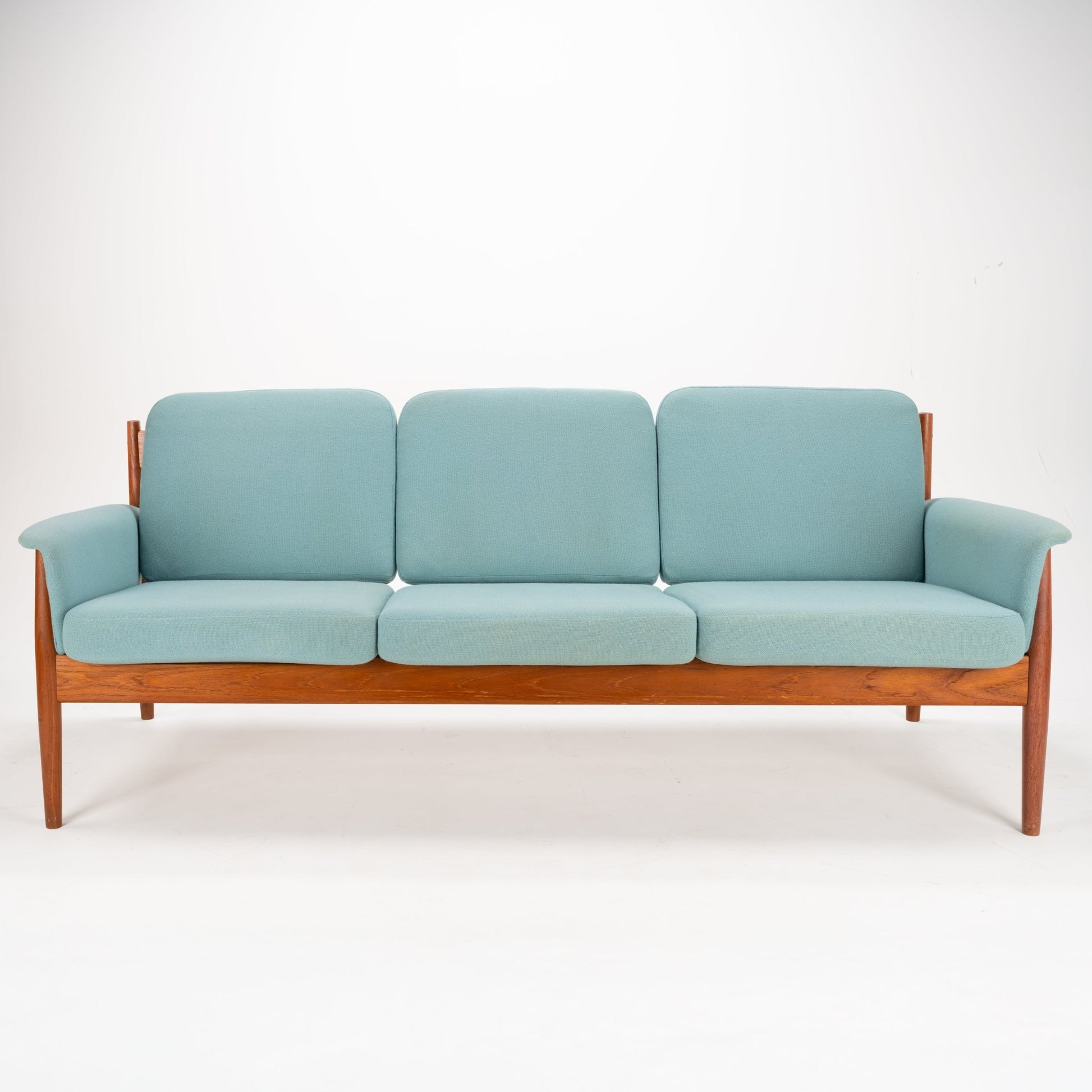 Grete Jalk Model 118 Teak Sofa showcasing a streamlined teak frame with gently tapered legs and armrests, featuring soft blue upholstered cushions for classic mid century modern seating.