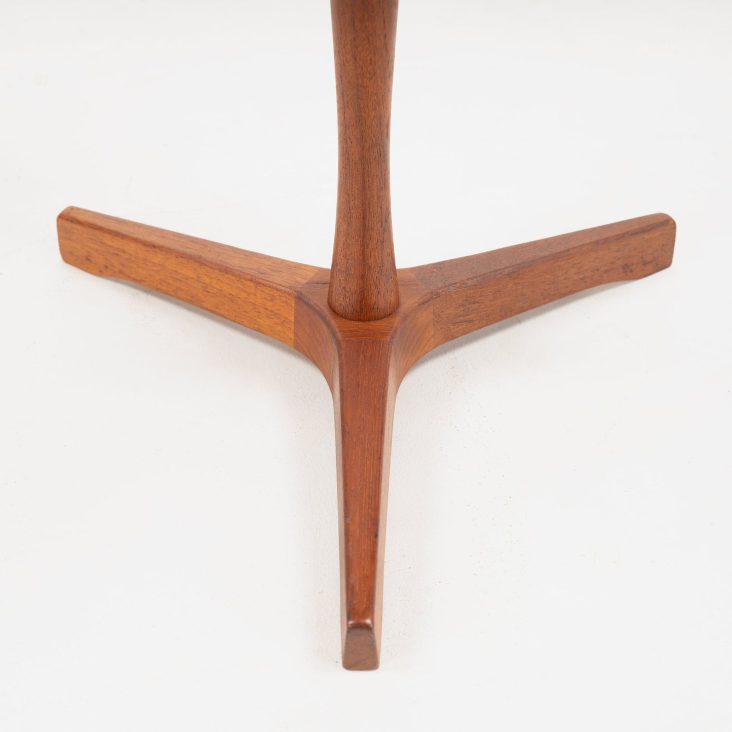 Hans Andersen Teak Tripod Side Table showcasing the tripod base’s warm teak wood with smooth, tapered legs converging at the slender central support, highlighting mid century modern furniture design.