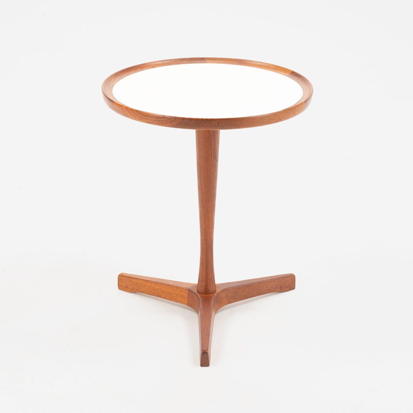 Hans Andersen Teak Tripod Side Table showcasing a sleek round white surface with a warm teak rim, supported by a slender central leg that extends into a tripod base, exemplifying elegant mid century modern furniture design.