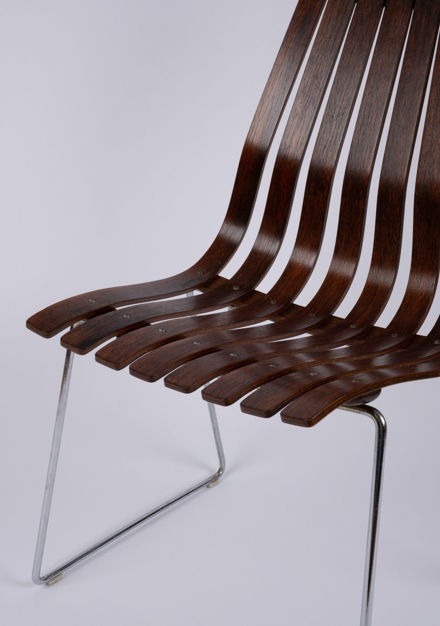 High back Hans Brattrud dining chair with curved laminated rosewood slats and chrome frame from 1960s Norway.