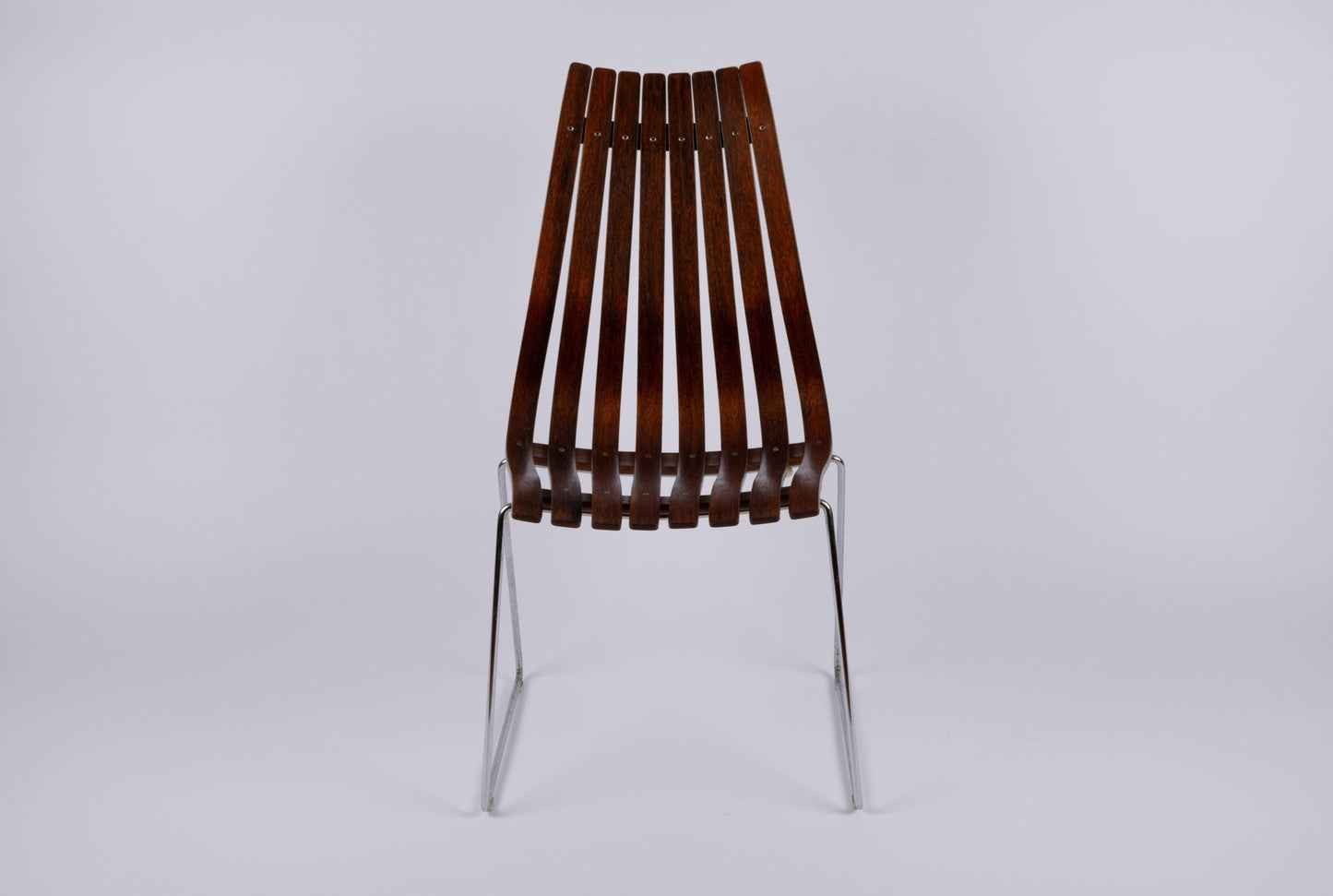 High back Hans Brattrud Mobler dining chair with curved laminated rosewood slats and chrome frame from 1960s Norway