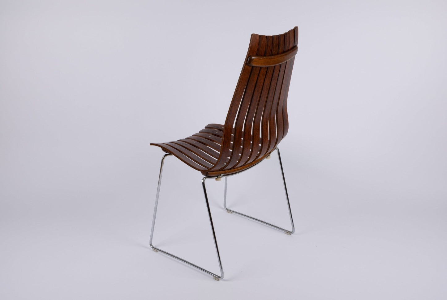 1960s Hans Brattrud Mobler dining chair with curved laminated rosewood slats and chrome frame from Norway.