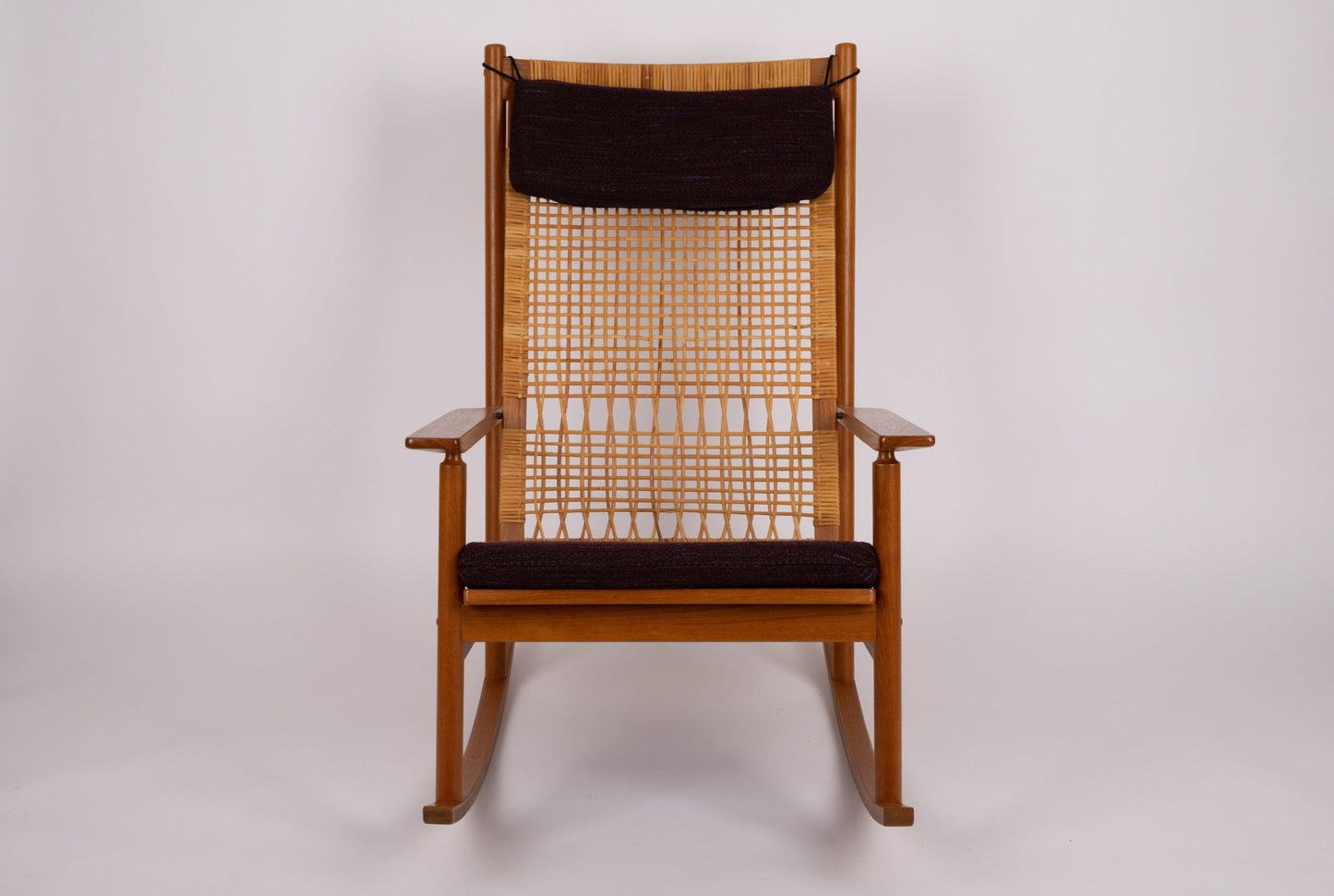 1960s Hans Olsen teak wood rocking chair with new cane seat and black upholstered cushions from Denmark