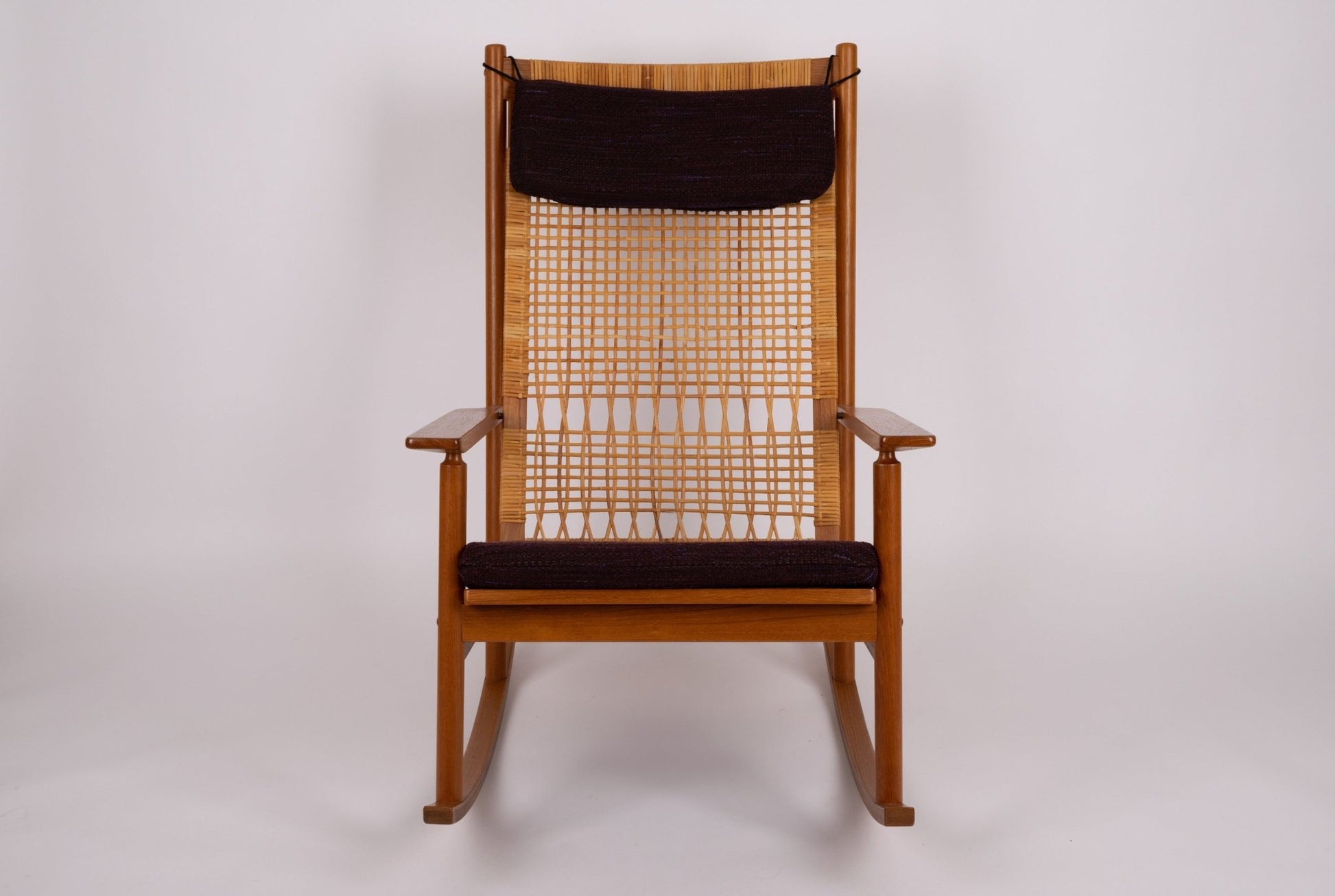 1960s Hans Olsen teak wood rocking chair with new cane seat and black upholstered cushions from Denmark