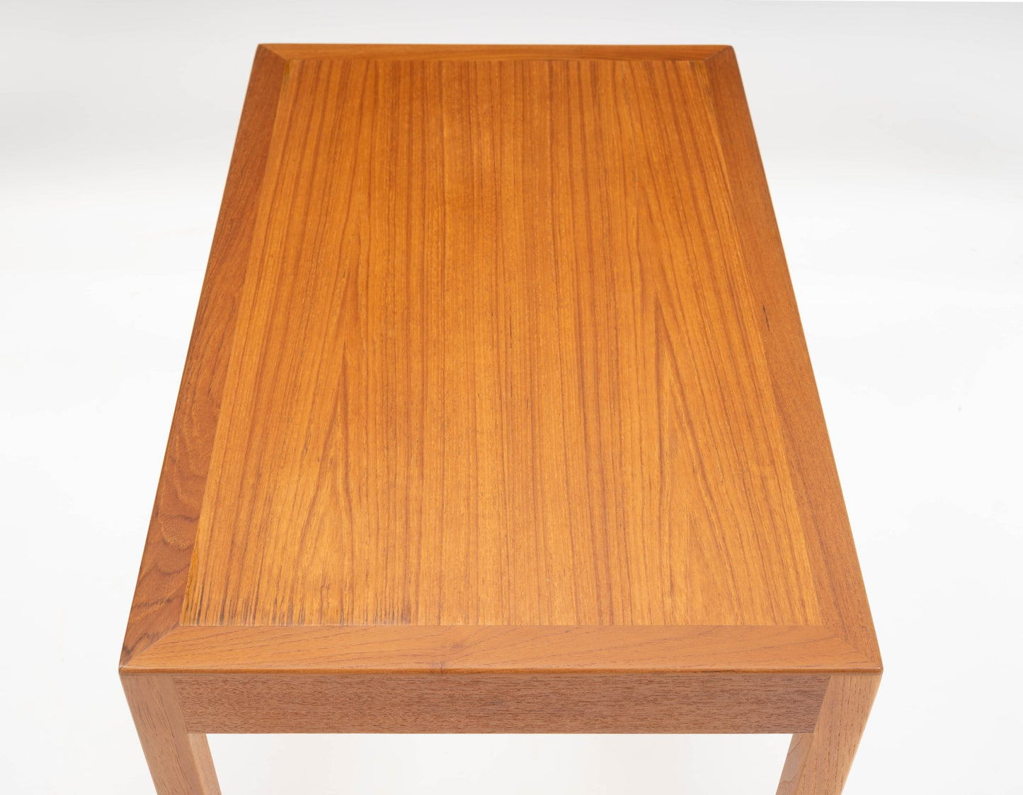 Pair of mid-century modern Danish teak side tables with rectangular tops and clean minimalist lines on white background