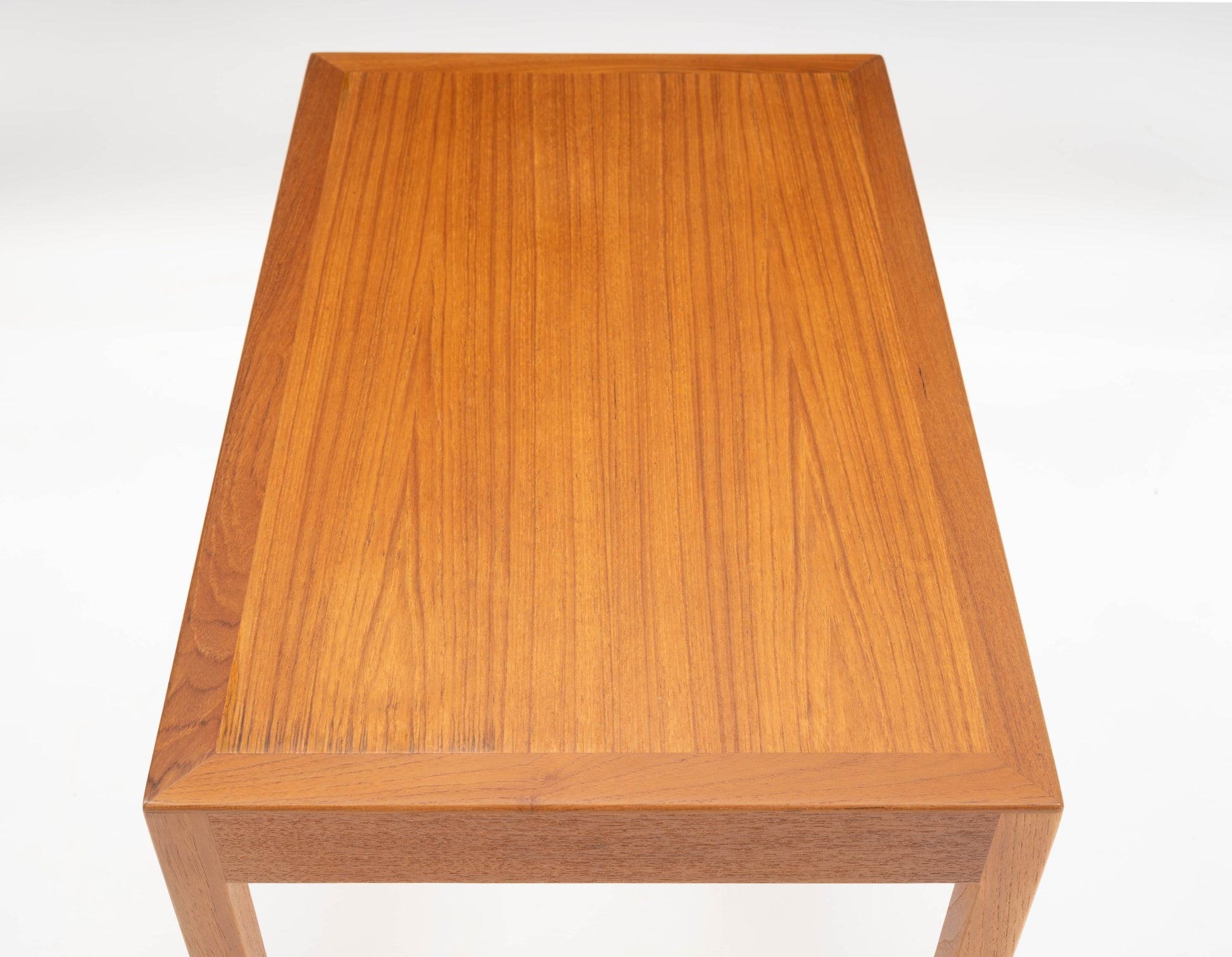 Pair of mid-century modern Danish teak side tables with rectangular tops and clean minimalist lines on white background