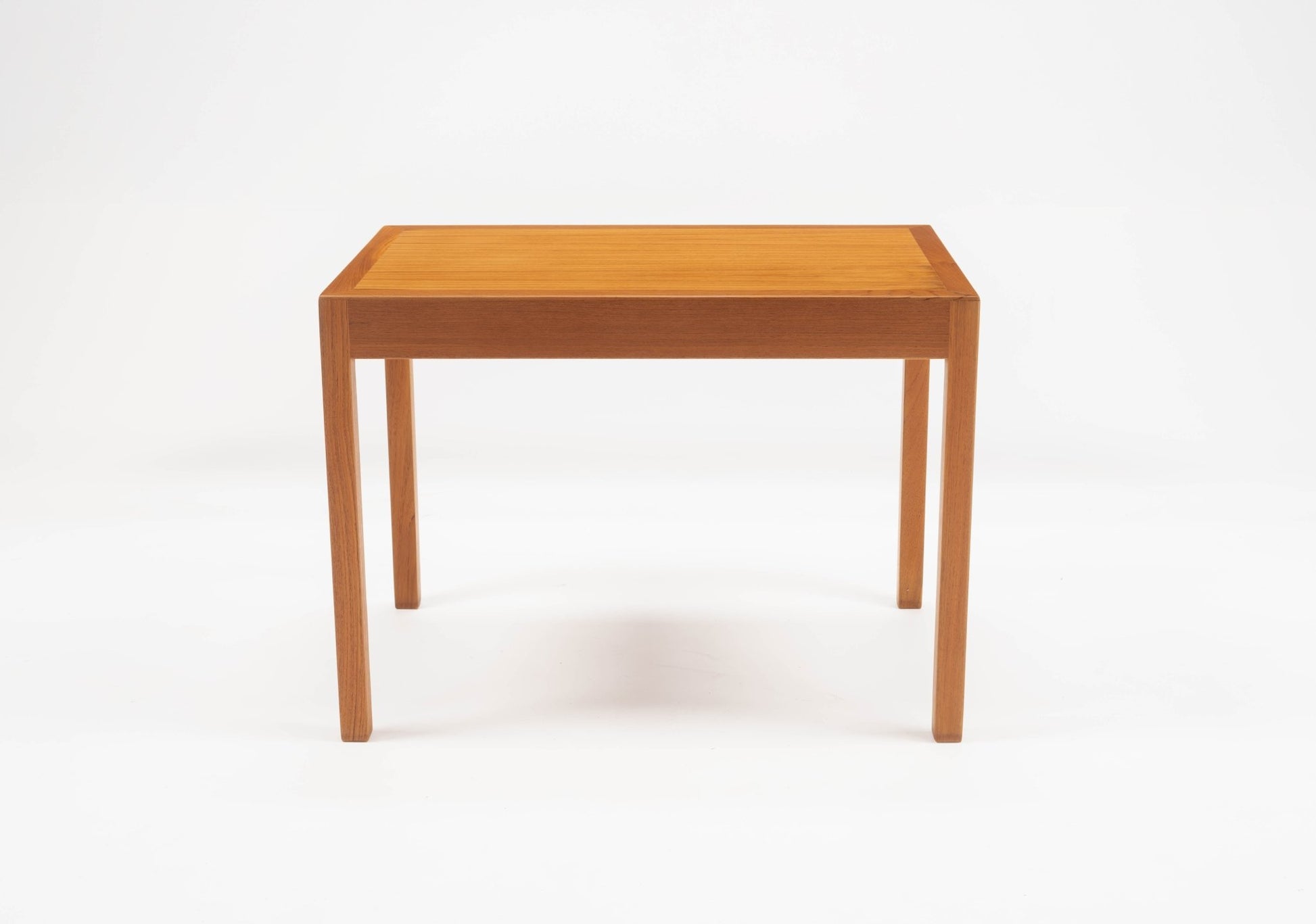 Hans Wegner mid-century modern teak side table with clean lines and minimalist rectangular design on white background