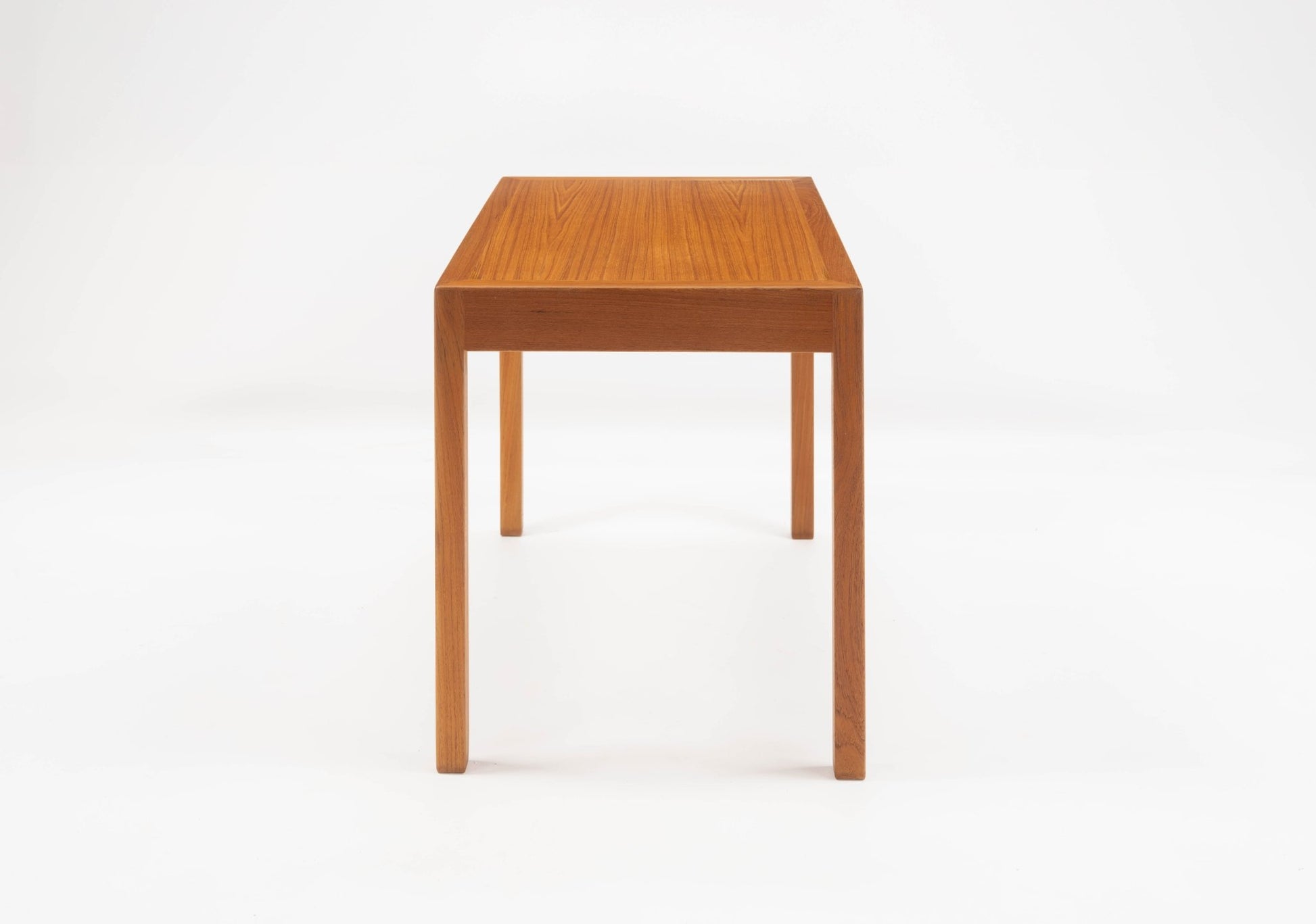 Hans Wegner pair of Danish teak side tables with minimalist rectangular tops and straight tapered legs on white background