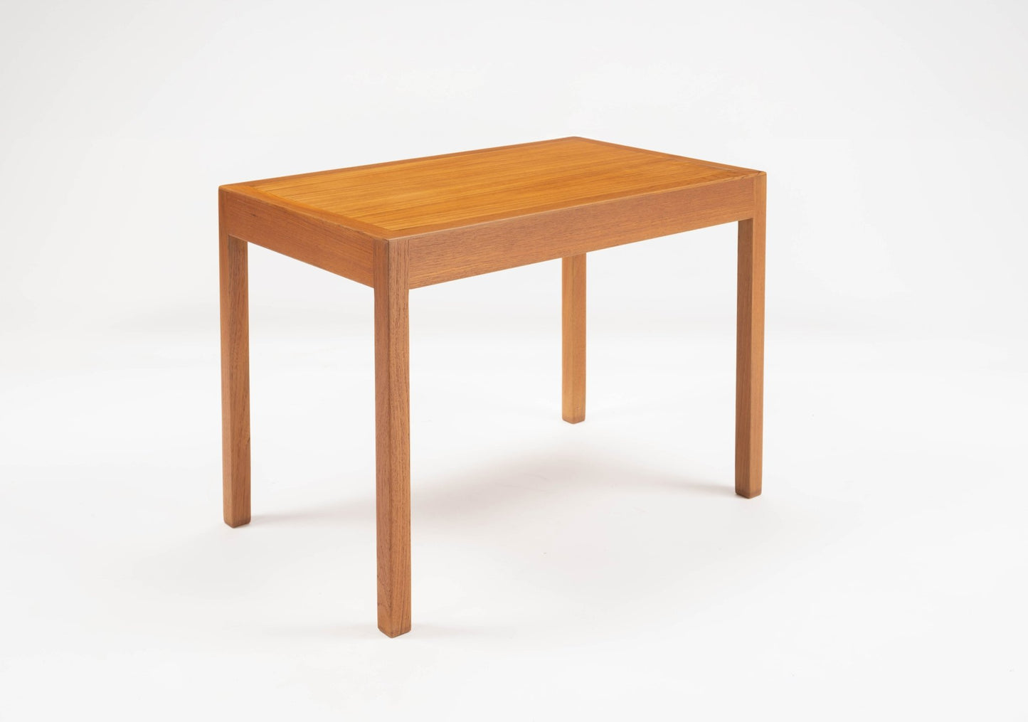 Hans Wegner pair of Danish teak side tables with minimalist rectangular tops and straight legs on white background