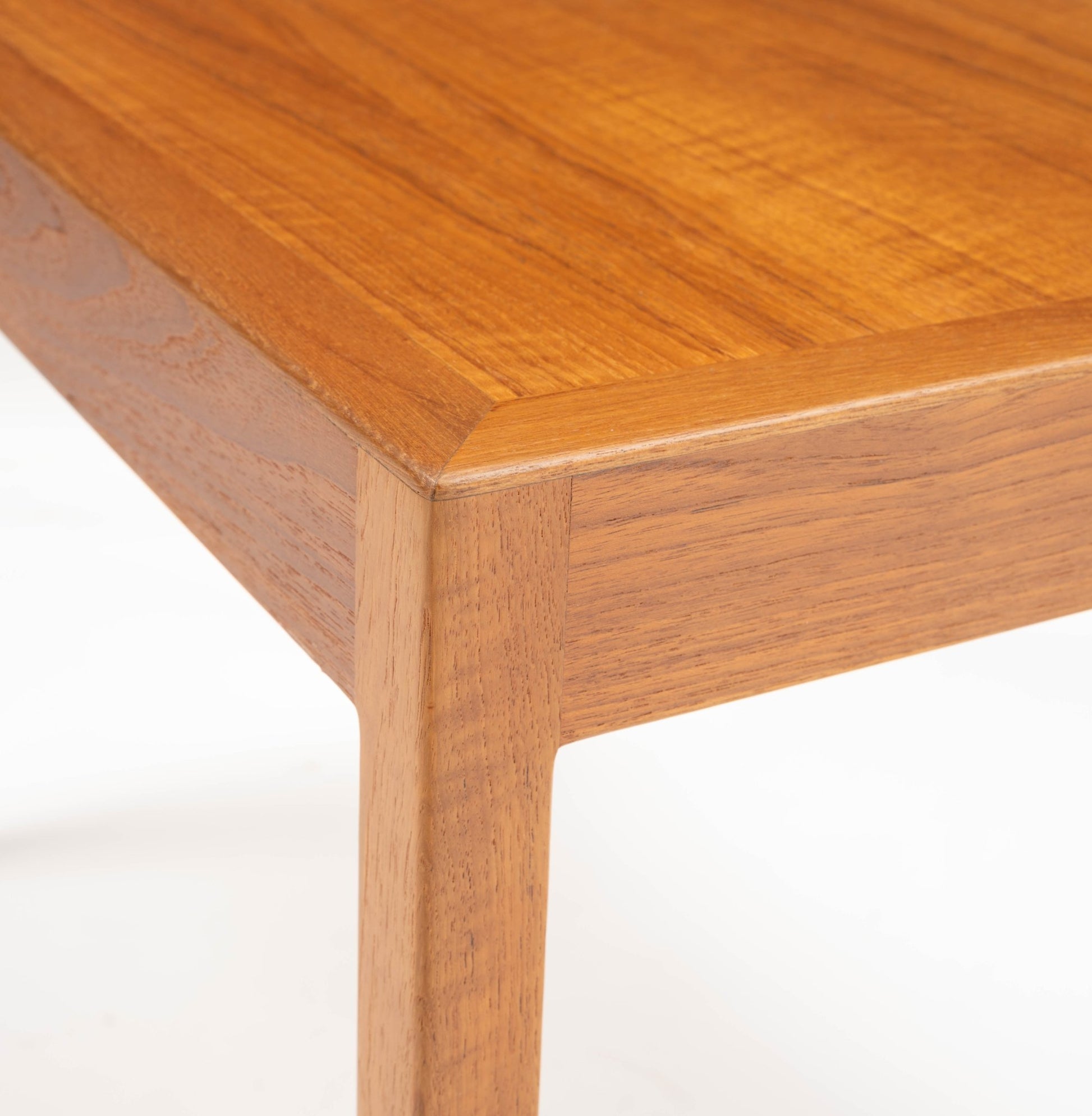 Close-up of Hans Wegner Danish teak side table corner highlighting clean lines and smooth wood grain finish