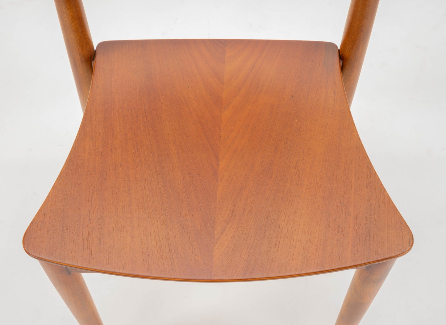 Mid-century modern Hvidt & Molgaard desk chair with curved teak seat and tapered beech legs on white background