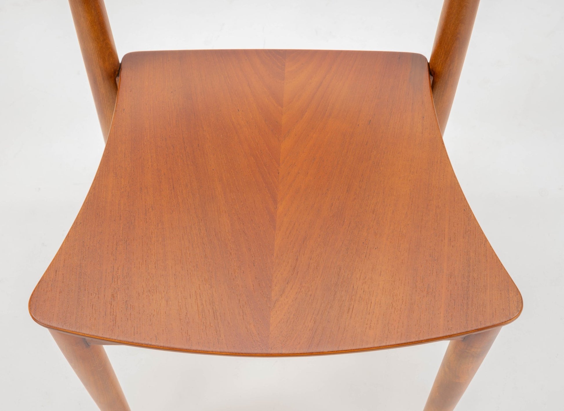 Mid-century modern Hvidt & Molgaard desk chair with curved teak seat and tapered beech legs on white background