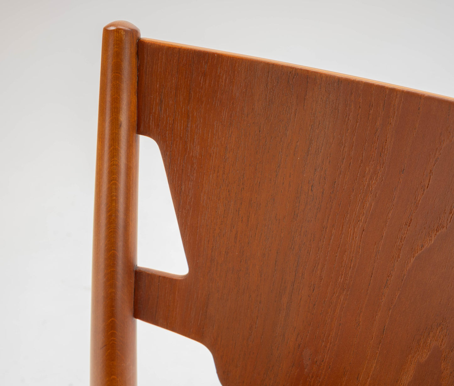 Close-up of mid-century modern Hvidt & Molgaard desk chair backrest in warm teak wood finish