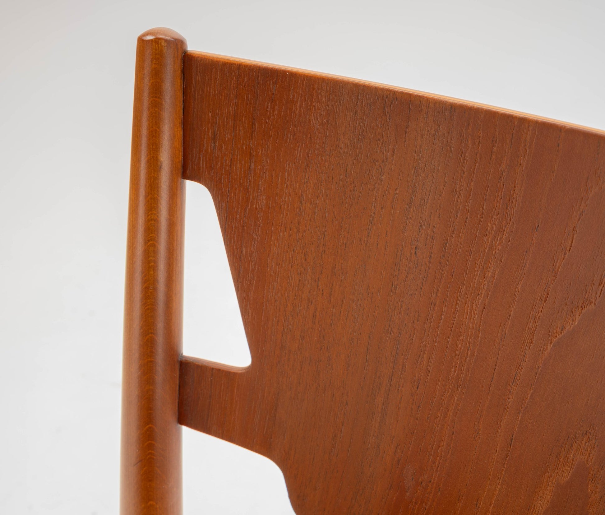 Close-up of mid-century modern Hvidt & Molgaard desk chair backrest in warm teak wood finish