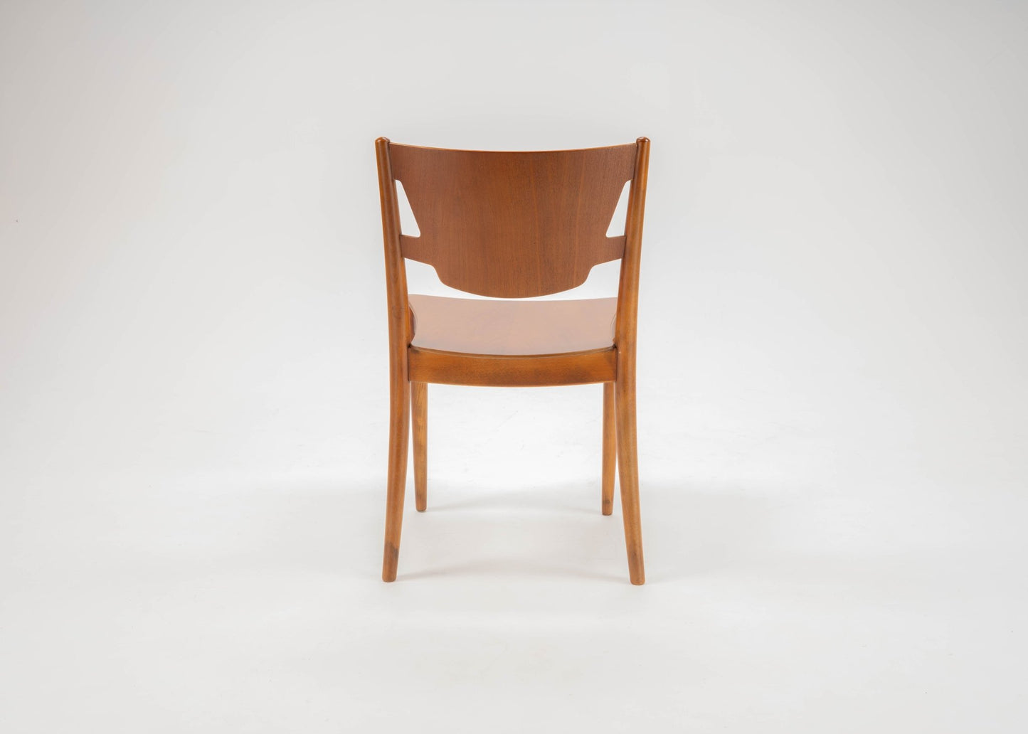 Mid-century modern Hvidt & Molgaard teak desk chair with curved backrest and tapered legs on white background