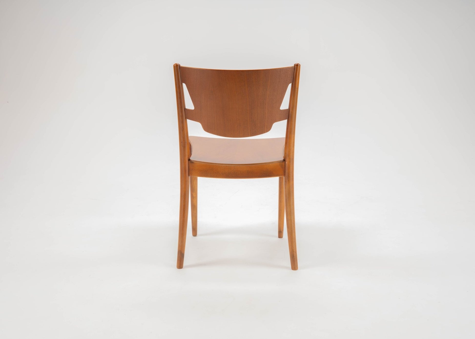Mid-century modern Hvidt & Molgaard teak desk chair with curved backrest and tapered legs on white background