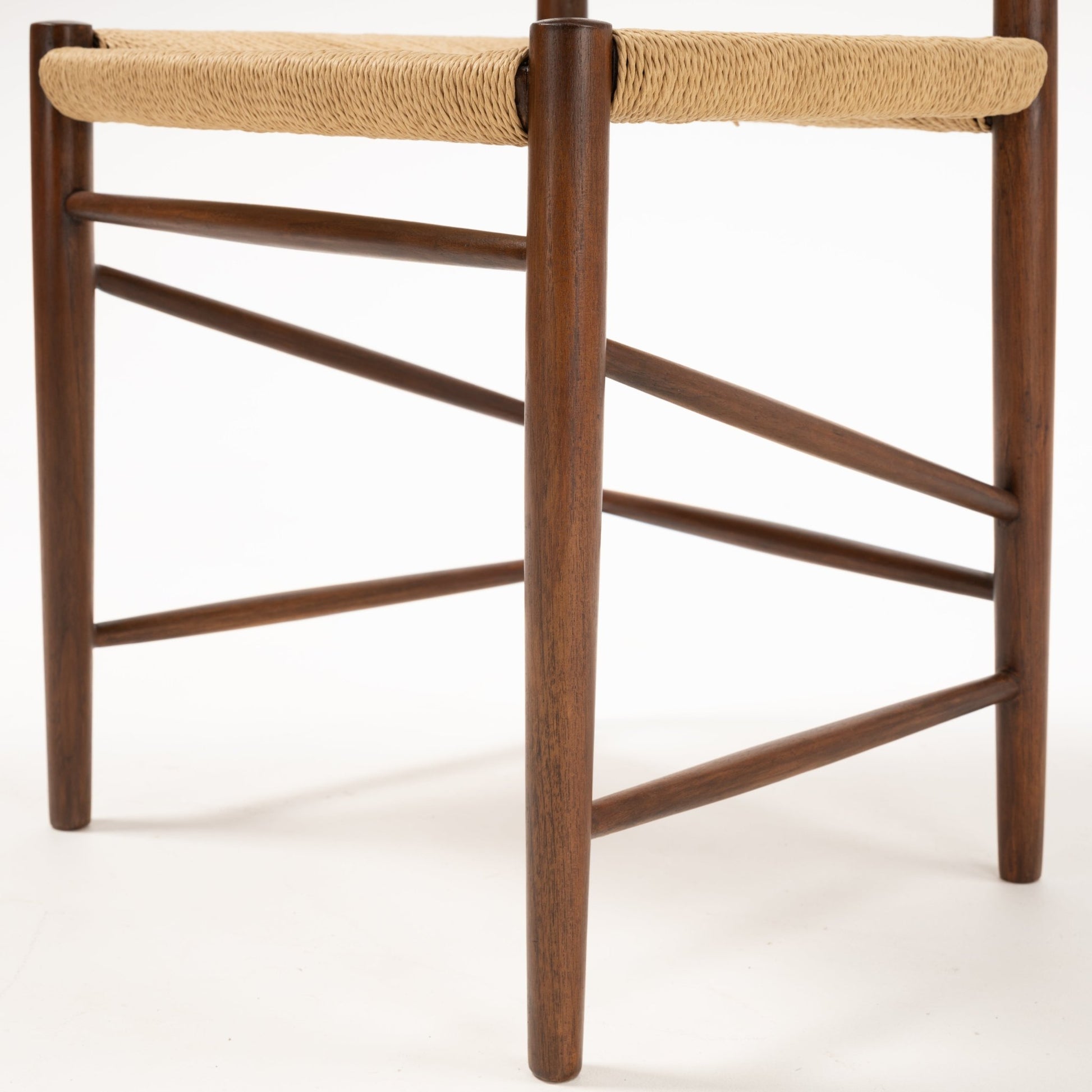 Close-up of dark teak wood frame and woven cane seat showcasing craftsmanship on Model 316 chair legs and stretchers