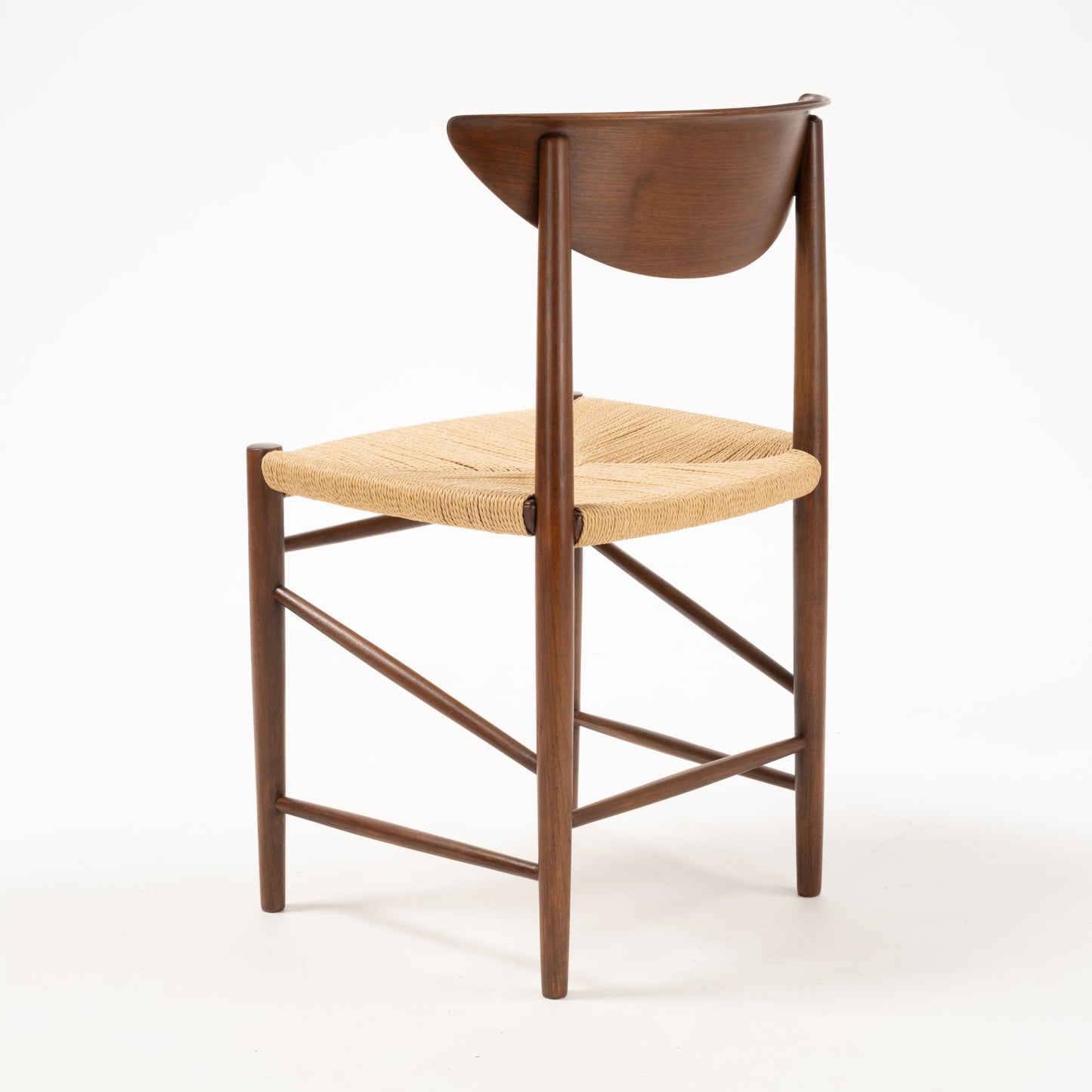 Rear view of Model 316 chair showing sculpted crescent-shaped teak backrest and woven natural fiber seat on slender frame