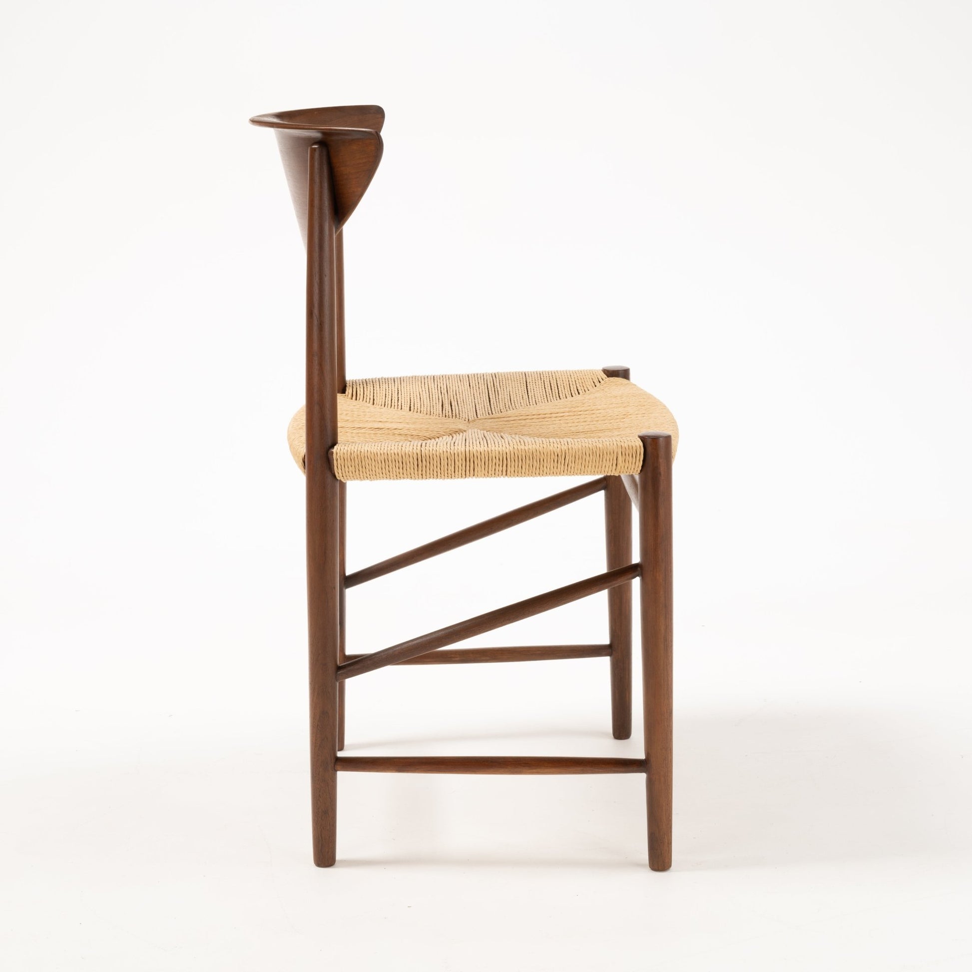 Side profile of Hvidt & Molgaard Model 316 chair with woven seat and sculpted teak backrest on tapered legs