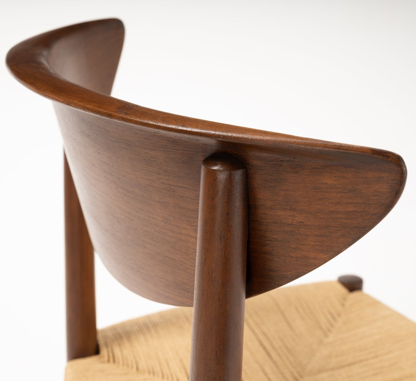 Close-up of the sculpted crescent-shaped solid teak backrest and woven seat details on Model 316 chair
