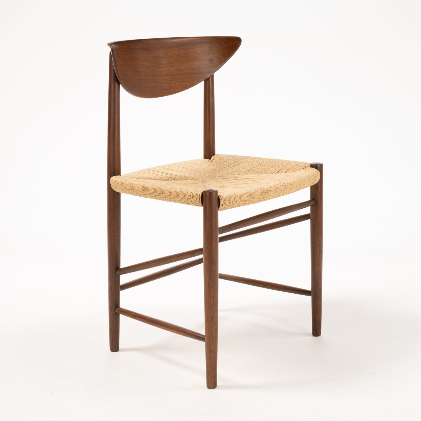 Angled view of Model 316 chair showing sculpted crescent teak backrest and woven natural fiber seat on solid wood frame