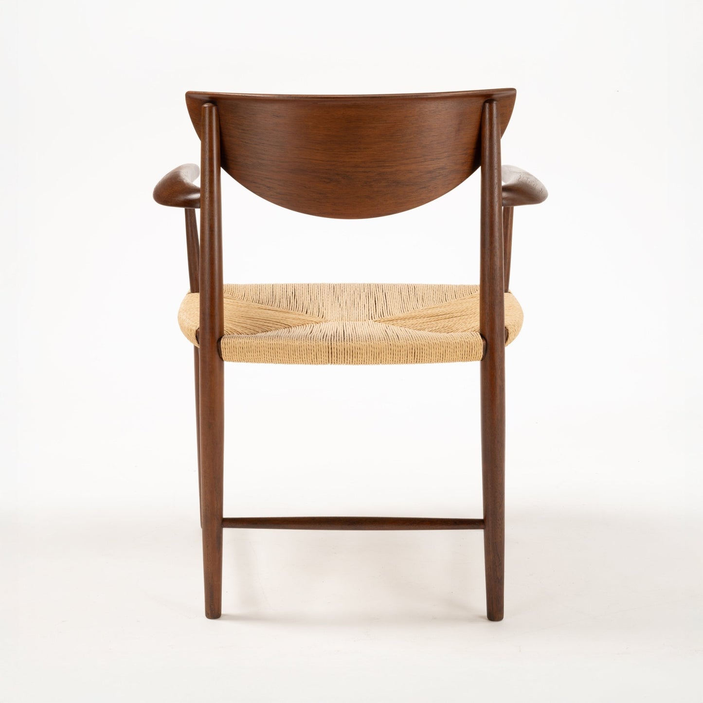 Rear view of Hvidt & Molgaard Model 317 chair with sculpted teak backrest and woven natural fiber seat on solid wood frame