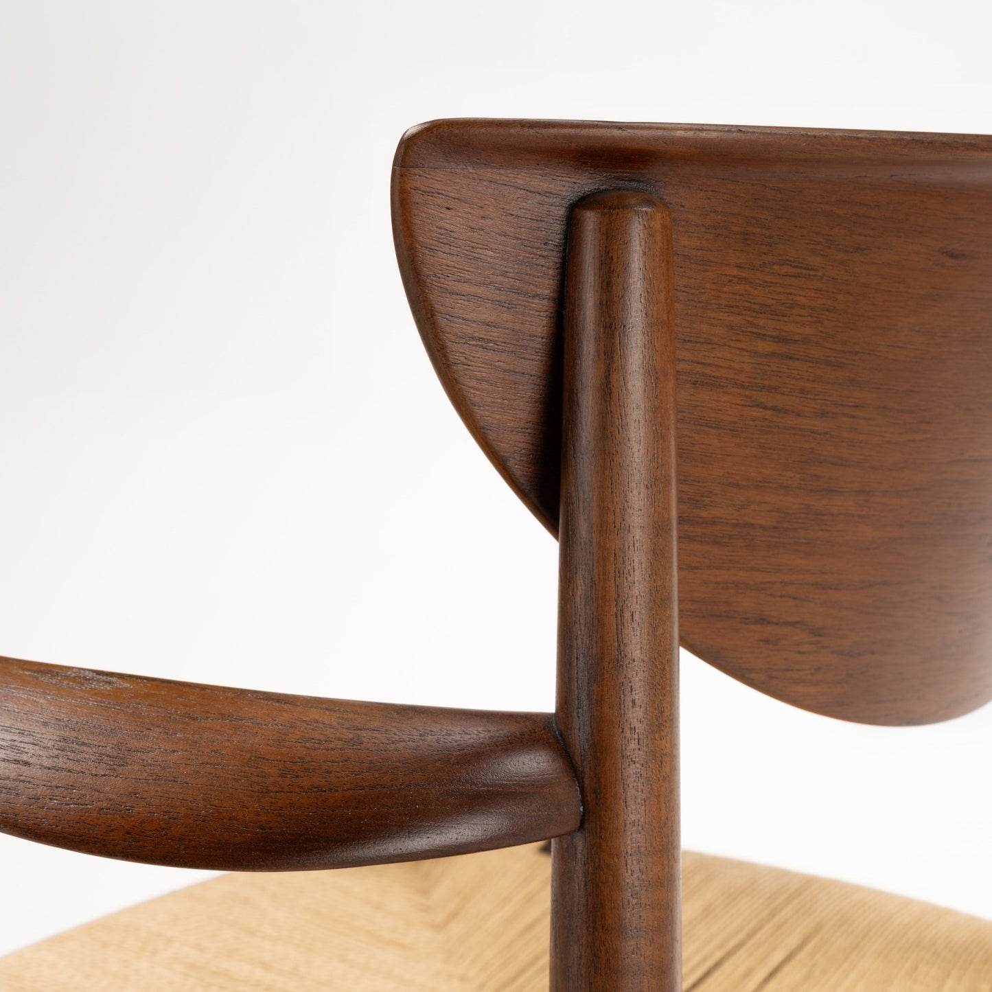 Close-up of Hvidt & Molgaard Model 317 chair’s smooth teak backrest joint and natural wood grain detail