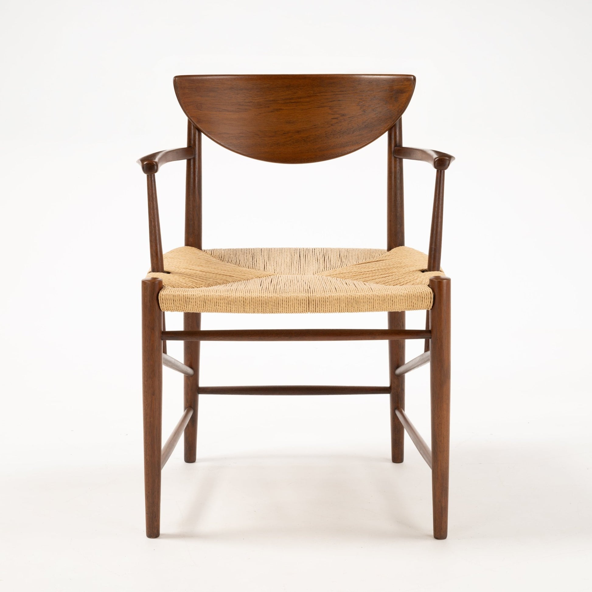 Front view of Hvidt & Molgaard Model 317 chair with crescent-shaped teak backrest and woven natural fiber seat