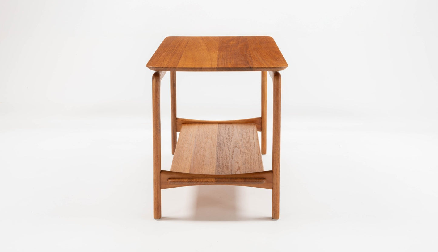 Mid-century modern teak side table with sculpted legs and two-tier design, crafted by Hvidt & Molgaard in Denmark.