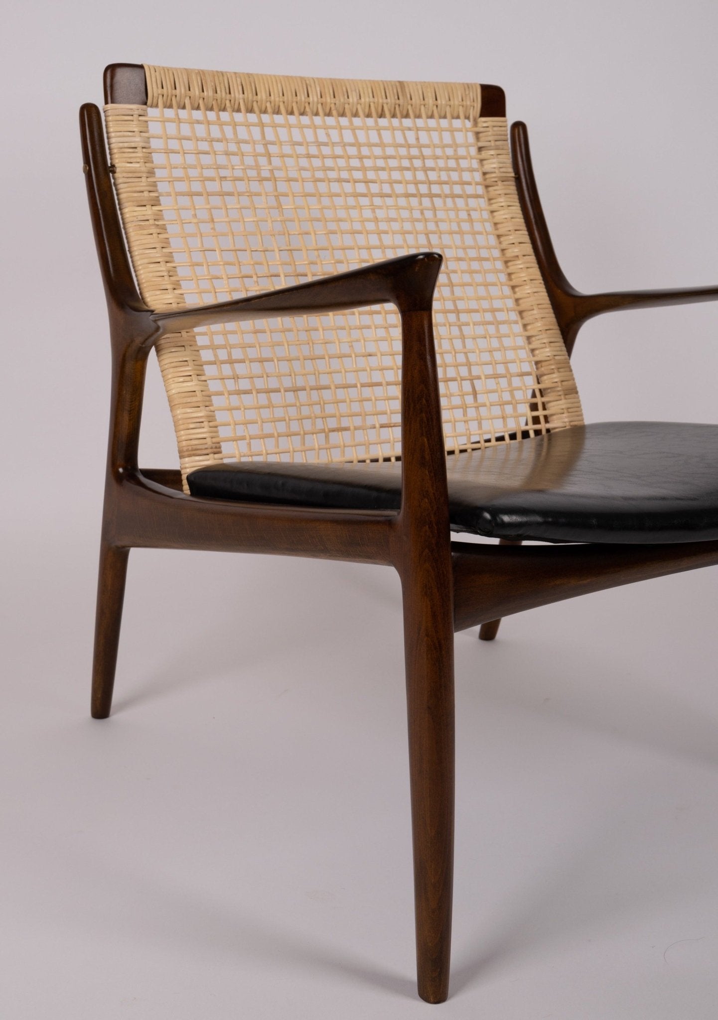 Ib Kofod Larsen model 18-15 chair with caned back and seat on teak frame, featuring original faux leather seat from the 1960s