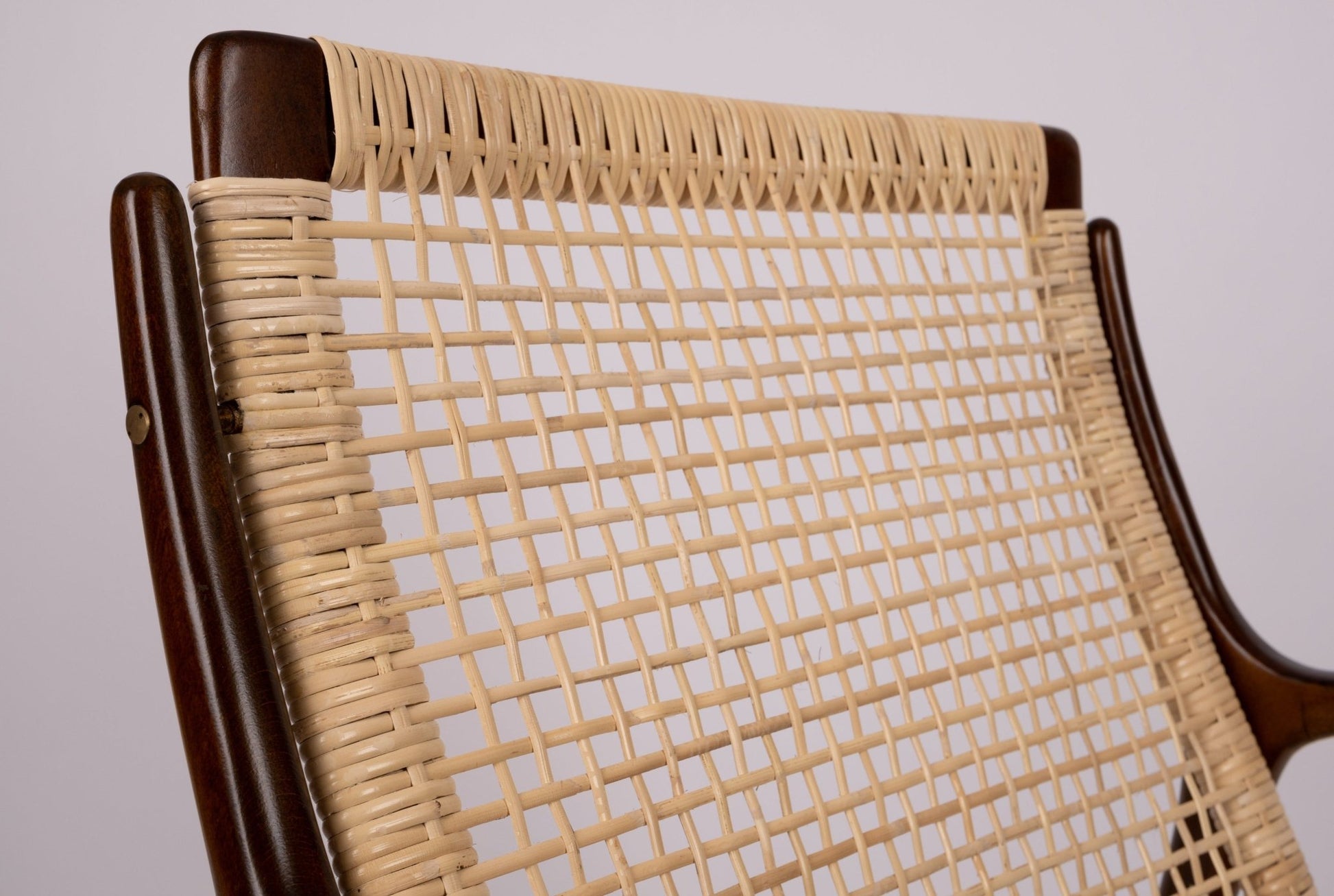 Close-up of Ib Kofod Larsen cane armchair with newly restored cane back and solid teak frame from Denmark, 1960s design.