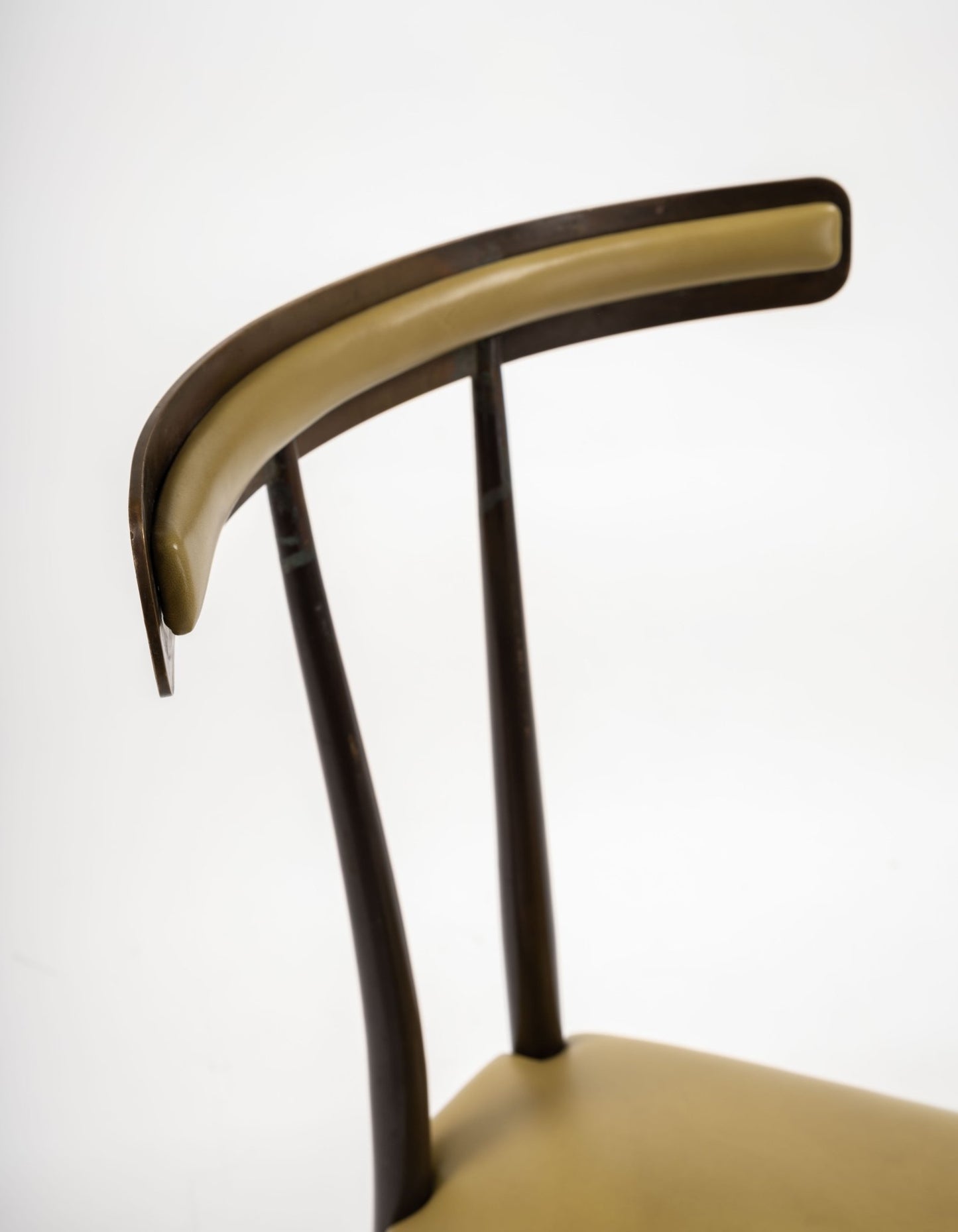 Close-up of Italian mid-century modern brass Klismos chair with curved backrest and chartreuse leather padding