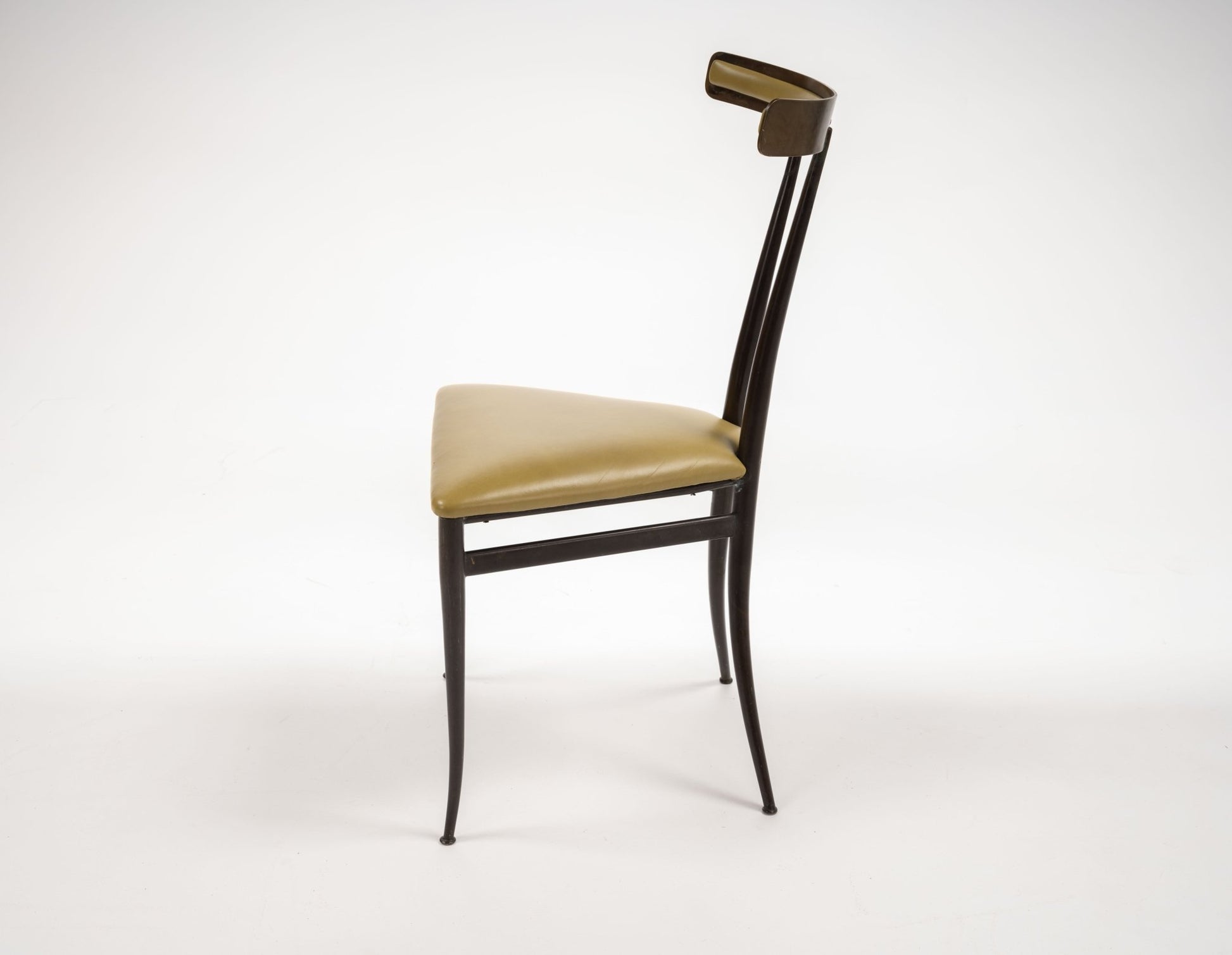 Side view of Italian mid-century modern brass Klismos chair with sculpted backrest and chartreuse leather seat