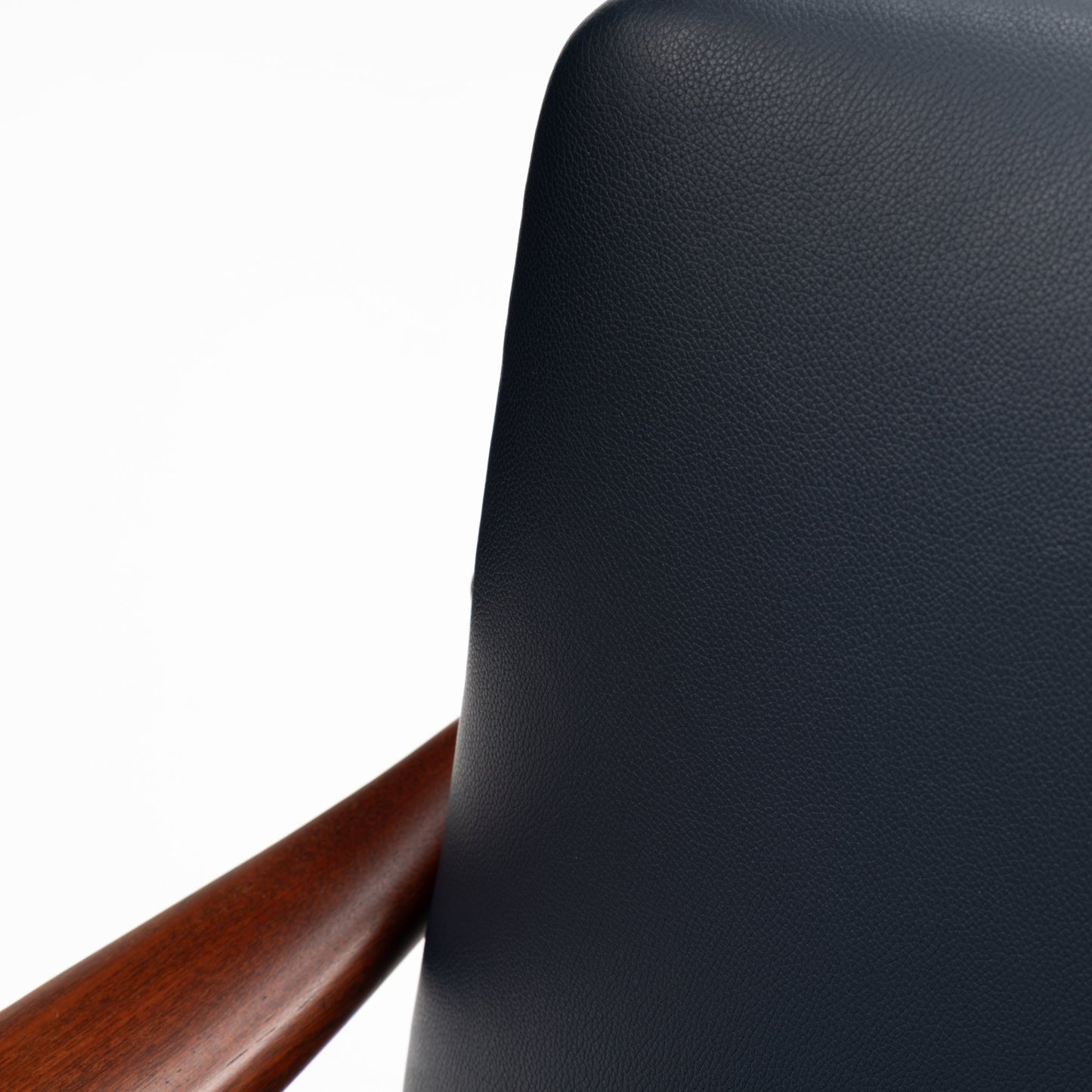 Jacob Kjaer Adjustable Lounge Chair close detail of black leather backrest and polished warm wood arm in mid century modern furniture style